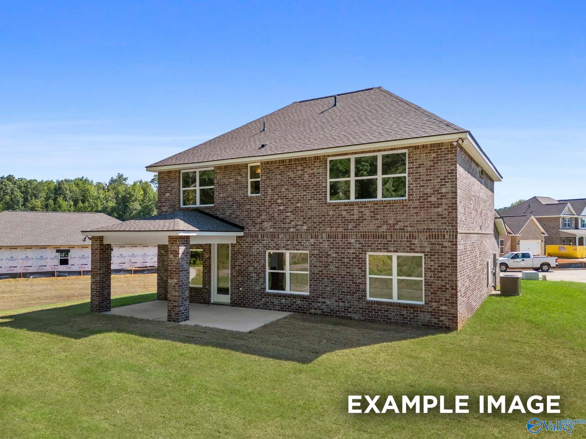 Two-story brick Shelby C home with covered porch, large windows, and green lawn in The Highlands, Arab, Alabama