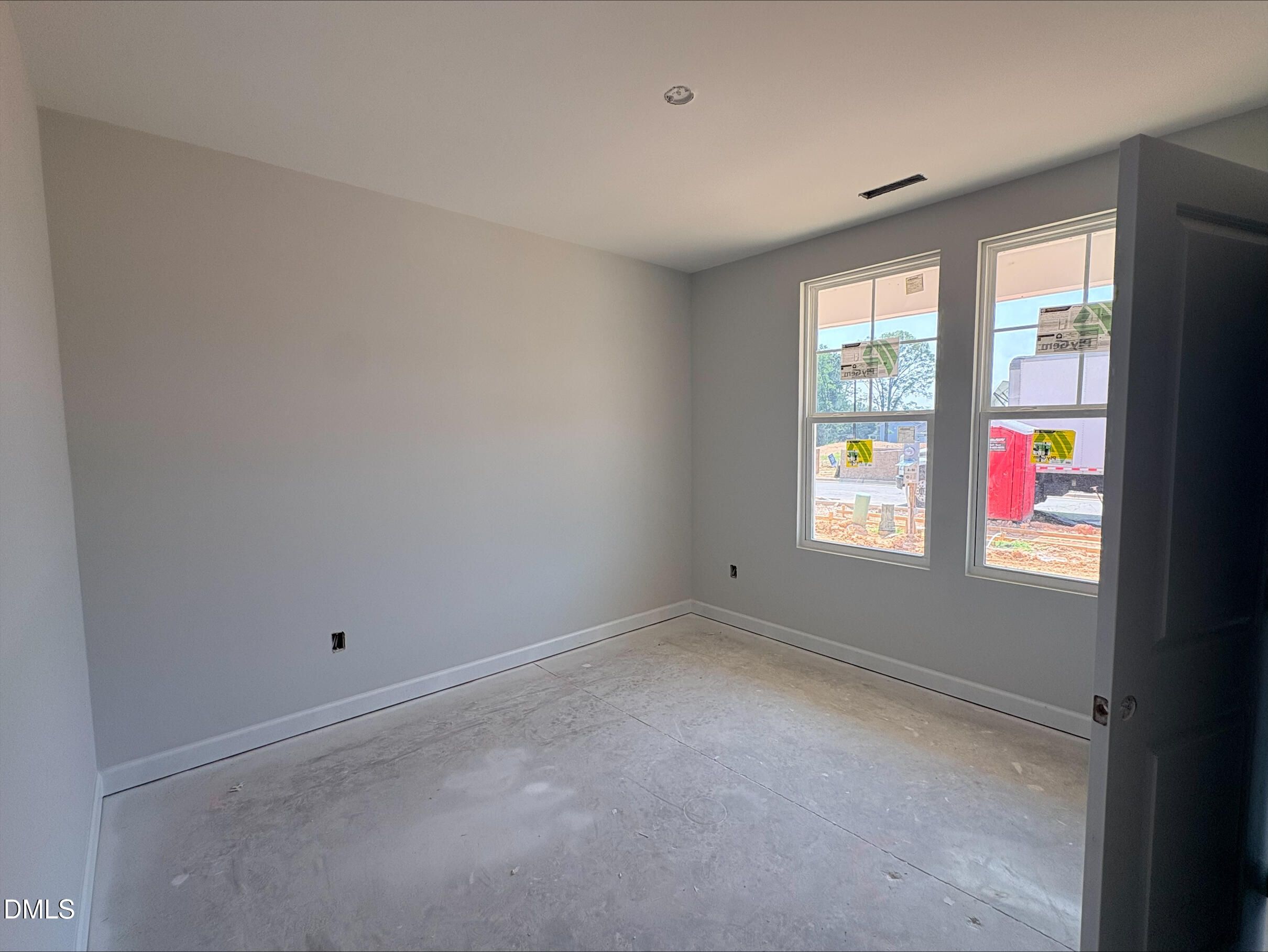 Bright, unfinished bedroom in The Daphne D floor plan by Davidson Homes at Woodland Crossing in Zebulon, North Carolina.