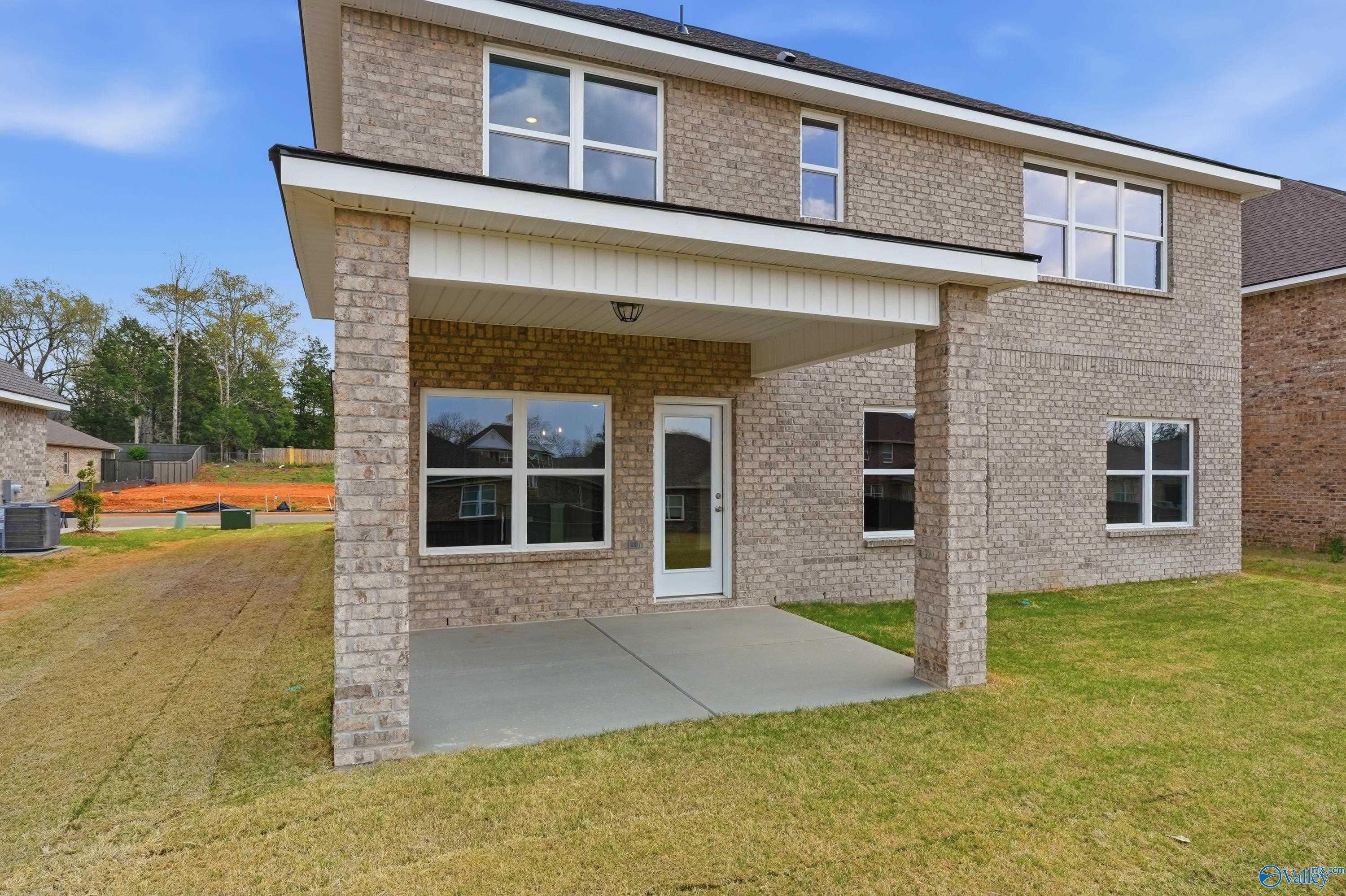 Covered back patio on two-story brick Davidson Homes Shelby B, 4-bedroom in Creek Grove, New Market, Alabama