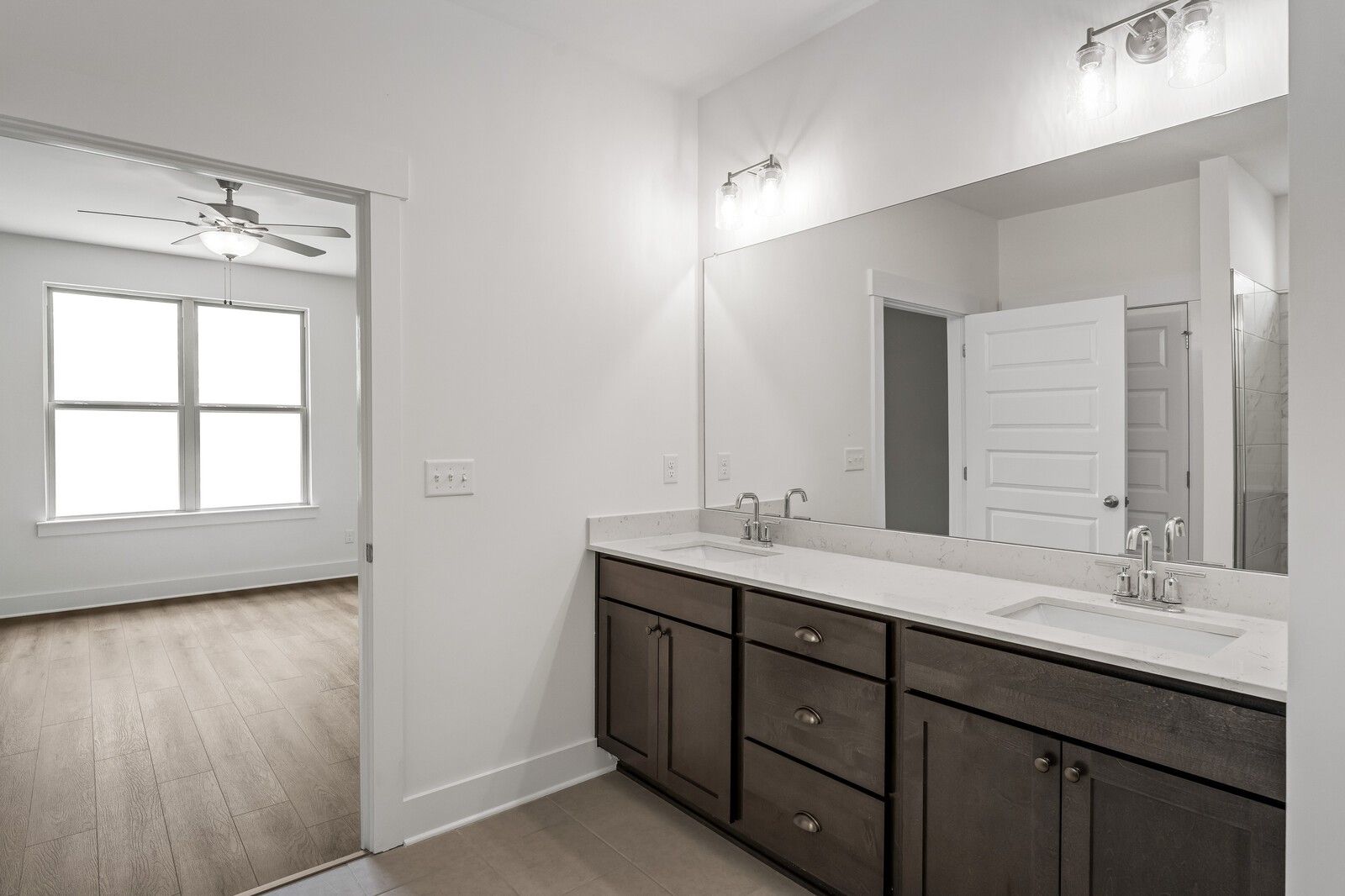 Modern double vanity with dark cabinets and quartz countertops in Davidson Homes Ridgeport C plan, Gallatin, Tennessee.
