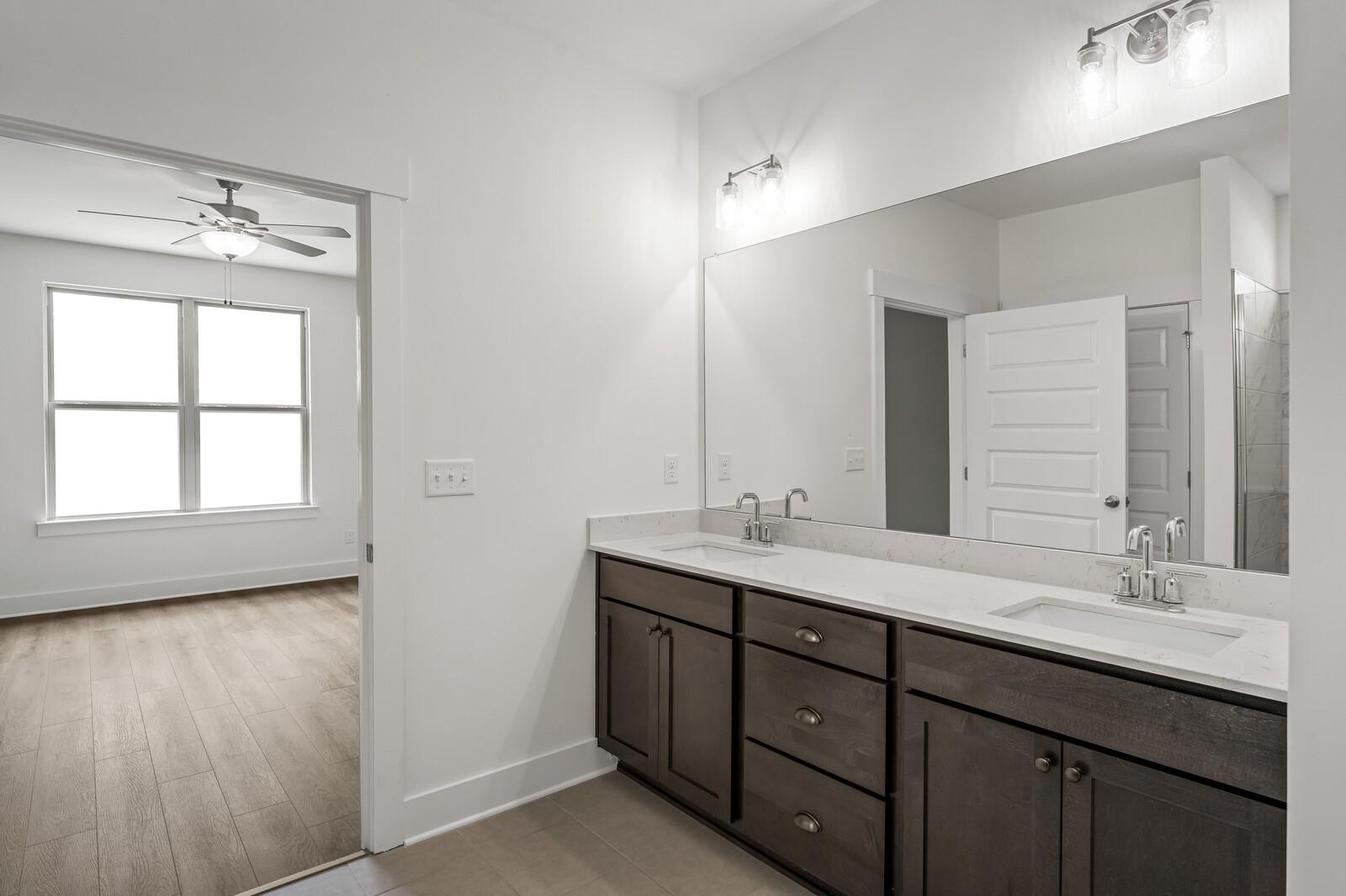 Modern double vanity with dark cabinets and quartz countertops in Davidson Homes Ridgeport C plan, Gallatin, Tennessee.