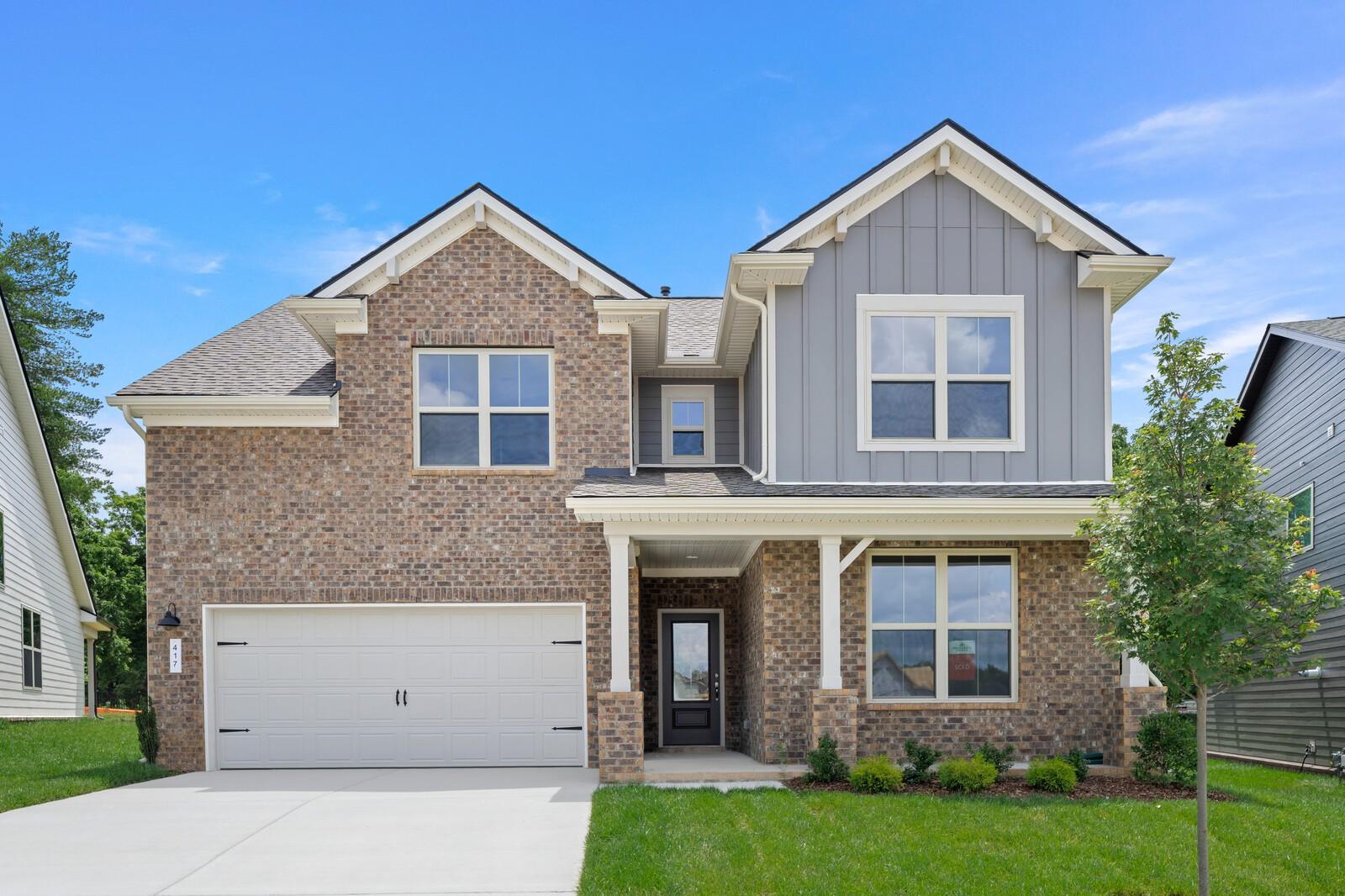 Two-story brick and siding home, The Ridgeport C floor plan, in Woods Crossing, Gallatin, Tennessee.