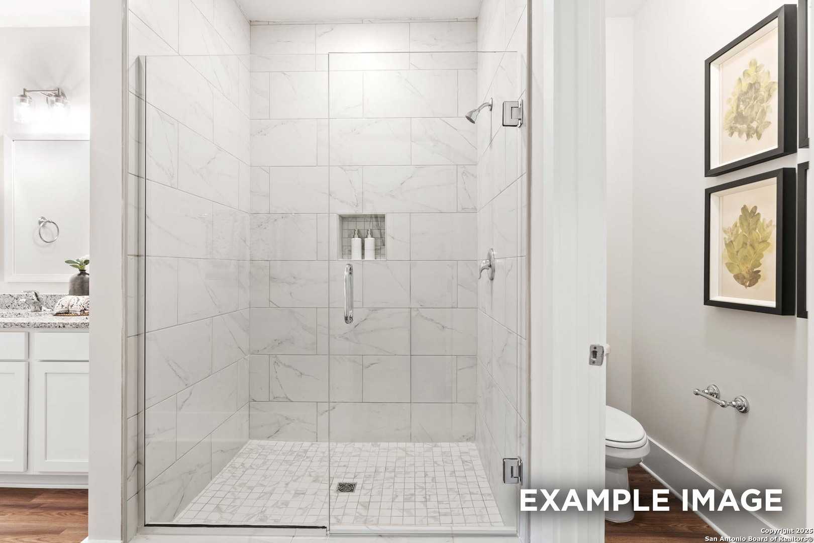 Modern master bath with frameless glass shower, white subway tiles, double vanity in Davidson Homes The Daphne H, Seguin, TX