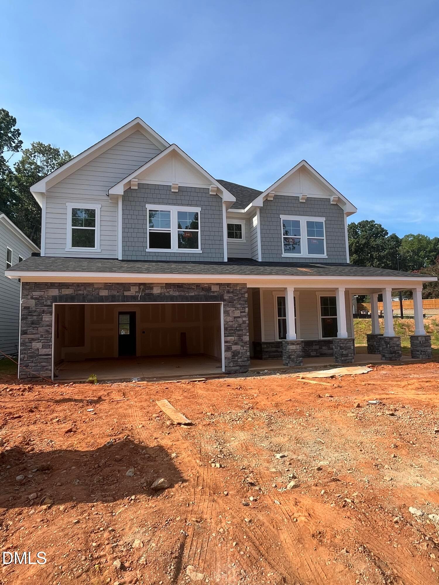 Two-story Willow G floor plan by Davidson Homes with stone facade and two-car garage in Sage on North Main, Wake Forest, NC.