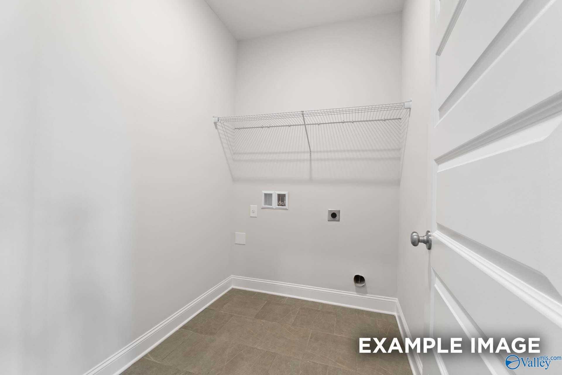 Bright laundry room with wire shelving, washer-dryer hookups, and utility sink in Davidson Homes The Montgomery, The Meadows, Athens, Alabama