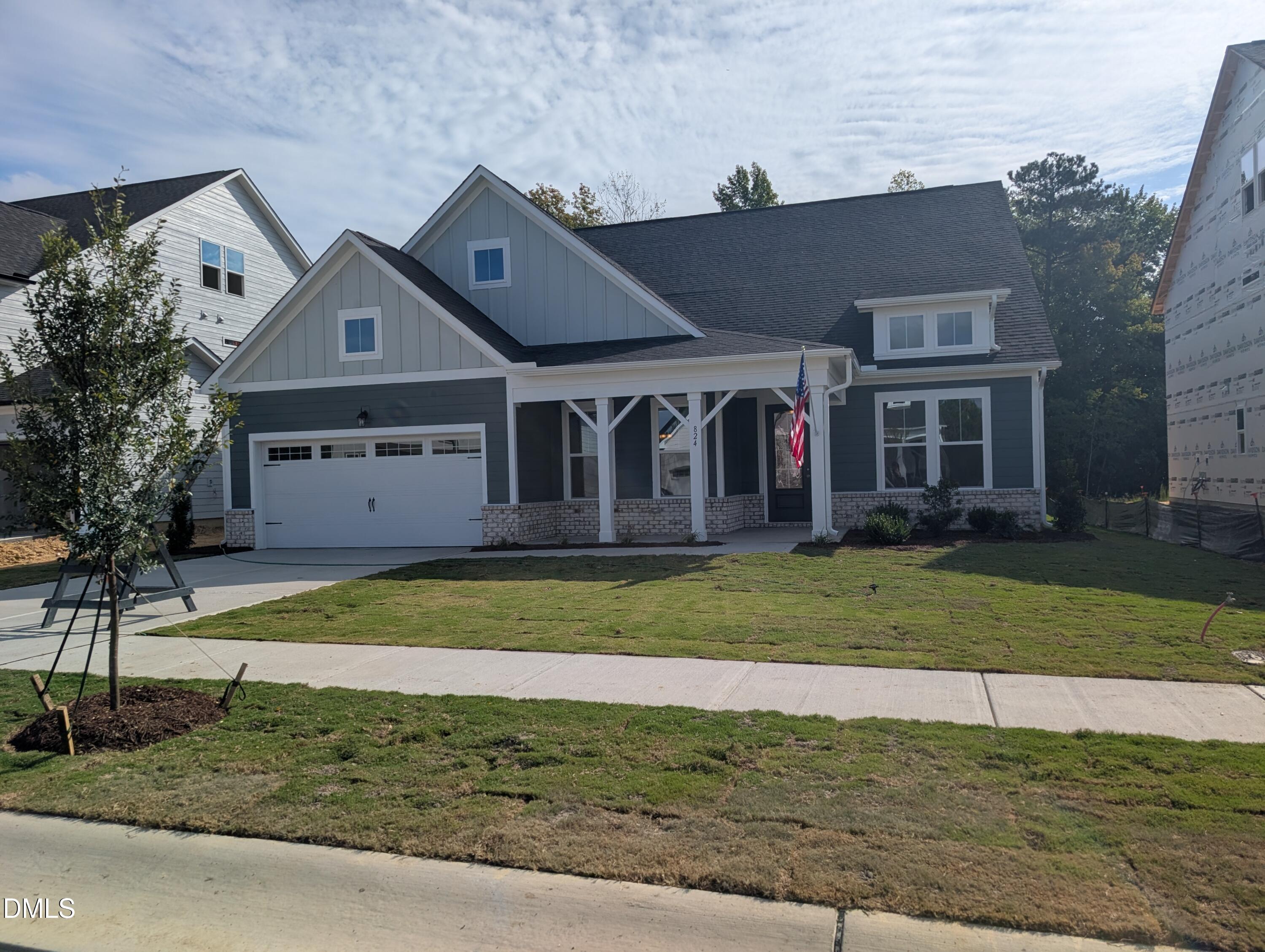 Gray two-story Davidson Homes Magnolia A with covered porch and 2-car garage in Wendell Ridge, Wendell, North Carolina