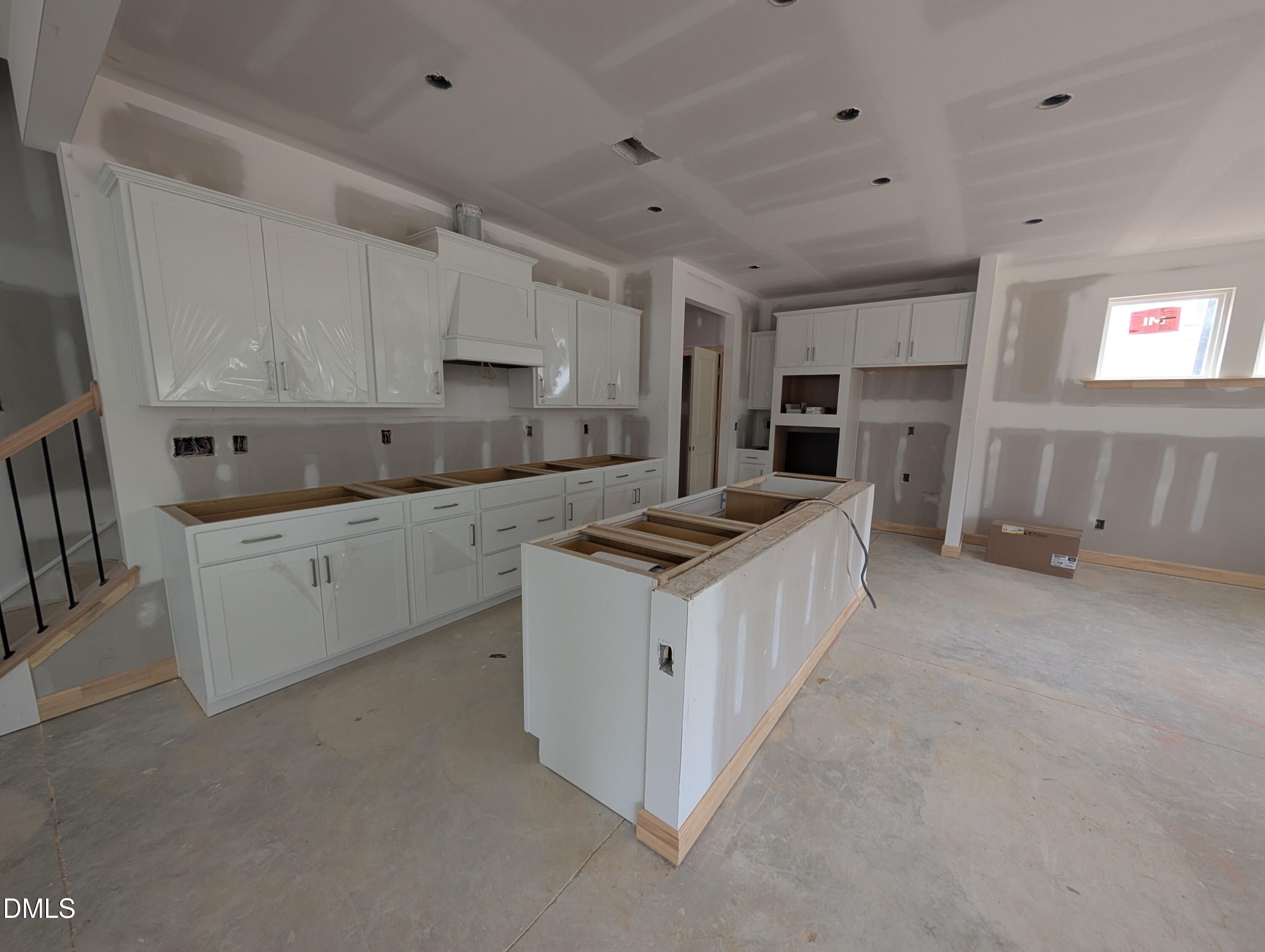 Kitchen under construction with white cabinets and island in The Beech floor plan by Davidson Homes, Wendell Ridge, North Carolina