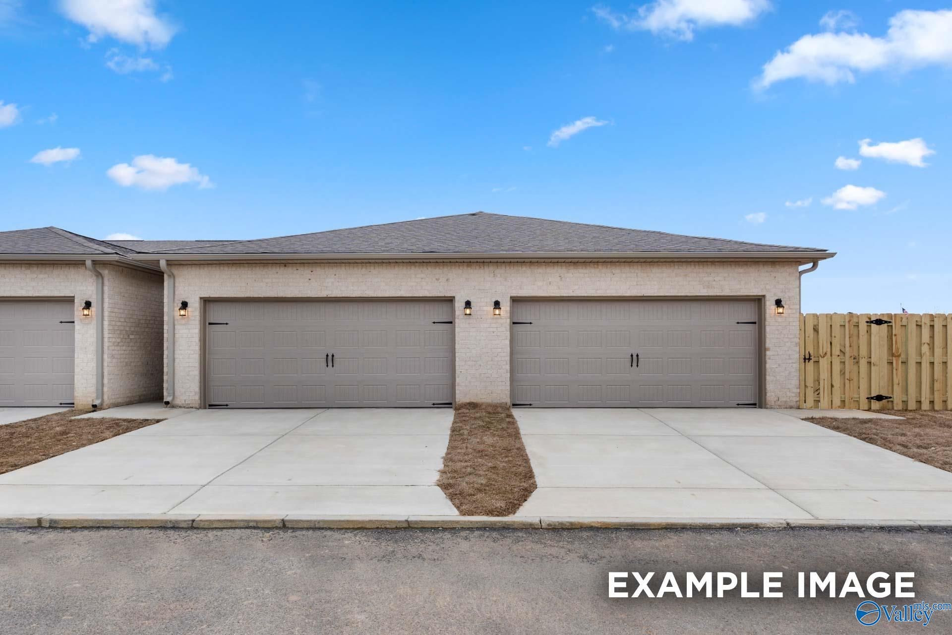Brick facade exterior with 2-car garage and double driveways at The Camilla C by Davidson Homes in Hartselle, Alabama