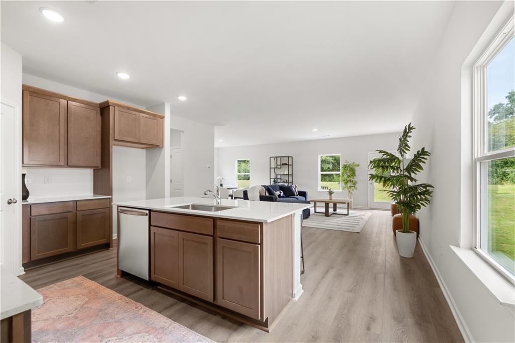 Open-concept kitchen with center island and living area in The Sinclair B floor plan at Cedar Farms, Winder, Georgia.