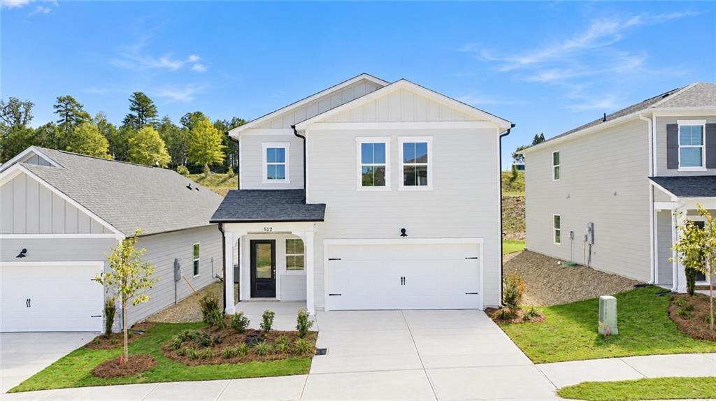 White two-story home exterior with 2-car garage and landscaped yard, Davidson Homes The Russell B in The Bluffs, Canton, GA