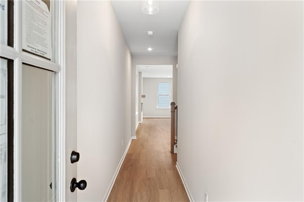 Bright hallway with light wood floors, white walls, and recessed lighting in The Marion A floor plan by Davidson Homes, Kennesaw, GA