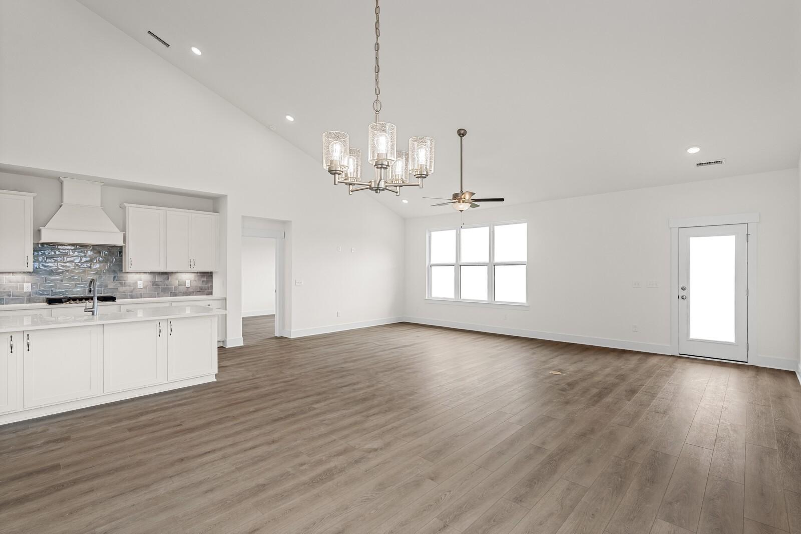 Open-concept living room and kitchen in The Ridgeport D floor plan by Davidson Homes in Benders Cove, Mt. Juliet, TN.
