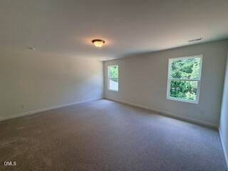 Spacious carpeted loft in The Willow B floor plan at Woodland Crossing, Zebulon, North Carolina.