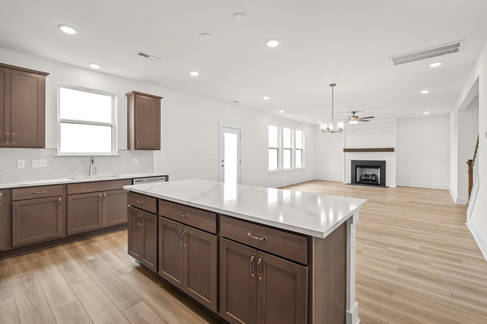 Open-concept kitchen with large island and living room fireplace in The Henry C floor plan, Benders Cove, Mt. Juliet, TN.