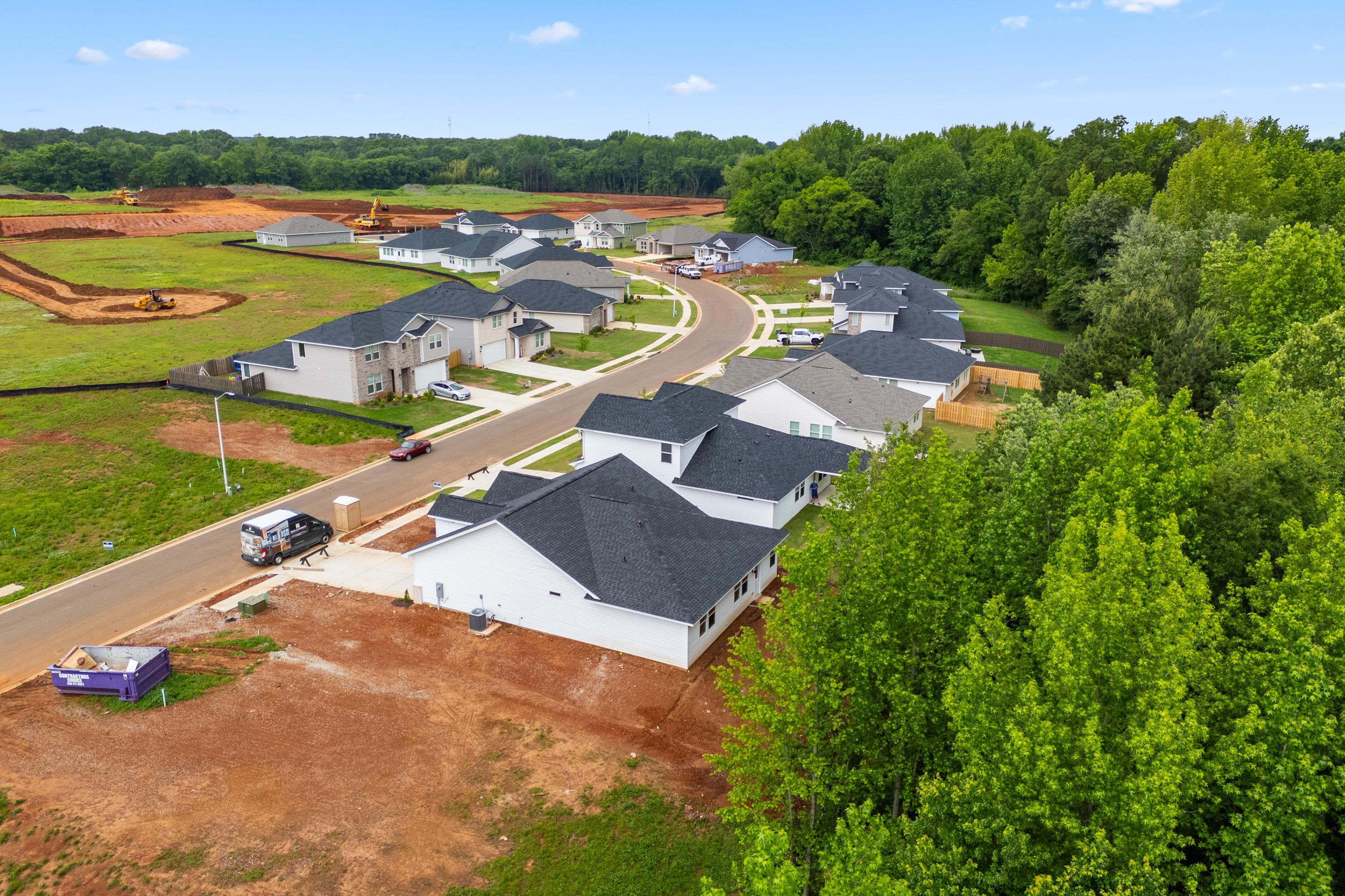 Aerial view of new homes in Forest Glen, Hazel Green Alabama by Davidson Homes amid wooded lots and construction sites