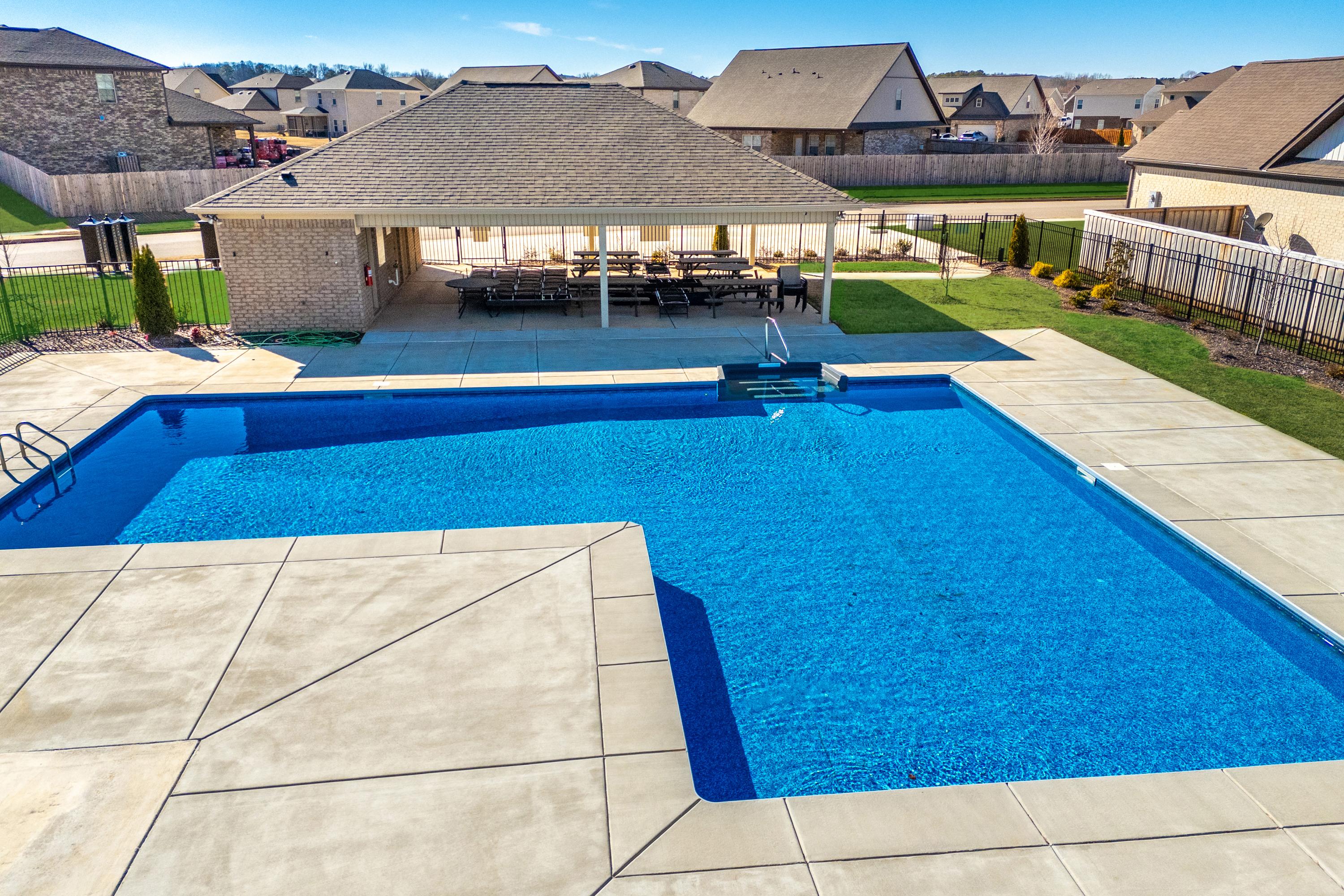 Resort-style swimming pool at Ivy Hills in Toney Alabama with covered pavilion, lounge seating and landscaped deck