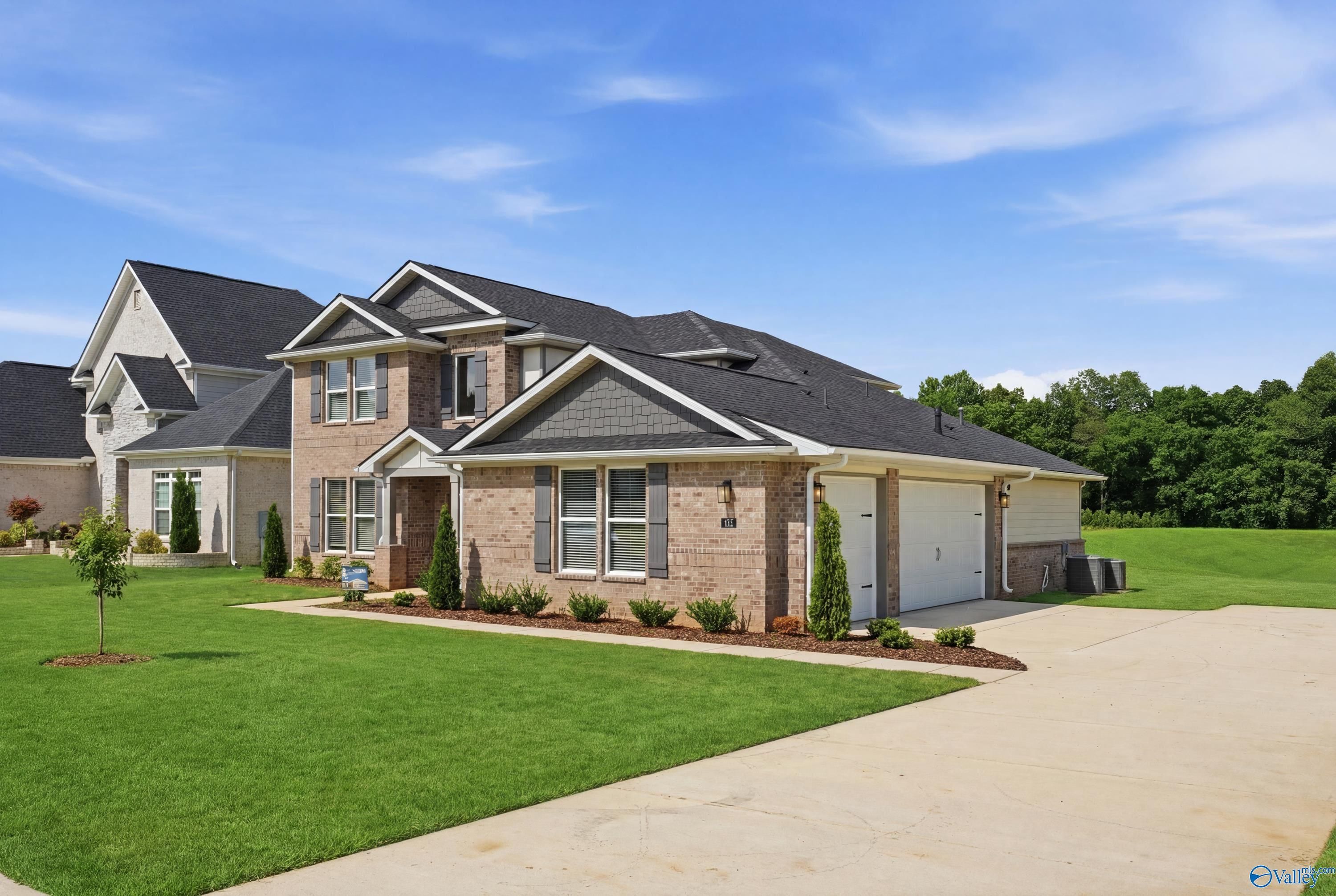 Two-story brick exterior of The Dorado floor plan by Davidson Homes in Riverton Preserve, Huntsville, Alabama.