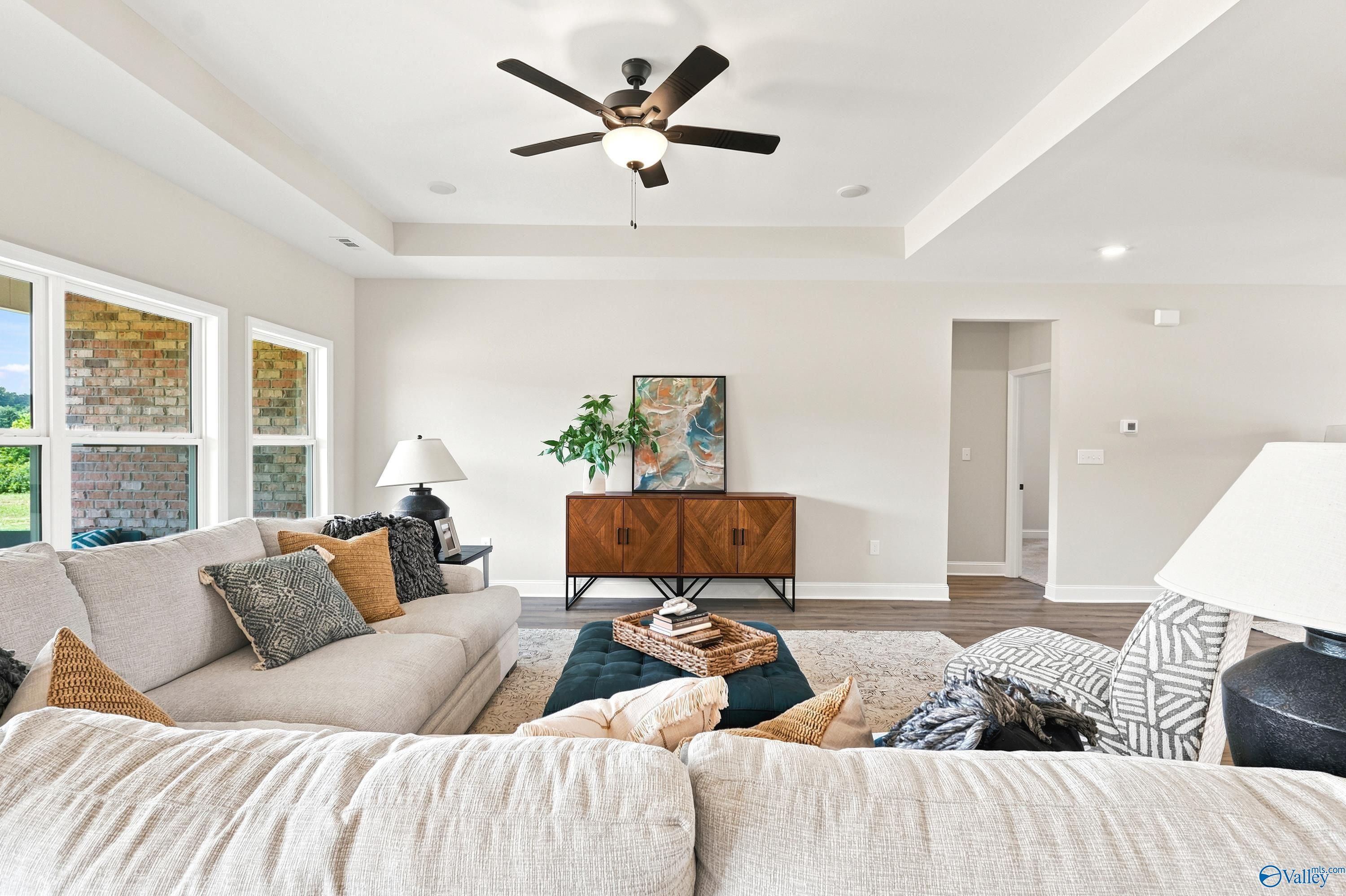 Spacious living room with tray ceiling in The Finleigh floor plan by Davidson Homes at Riverton Preserve, Huntsville, AL.