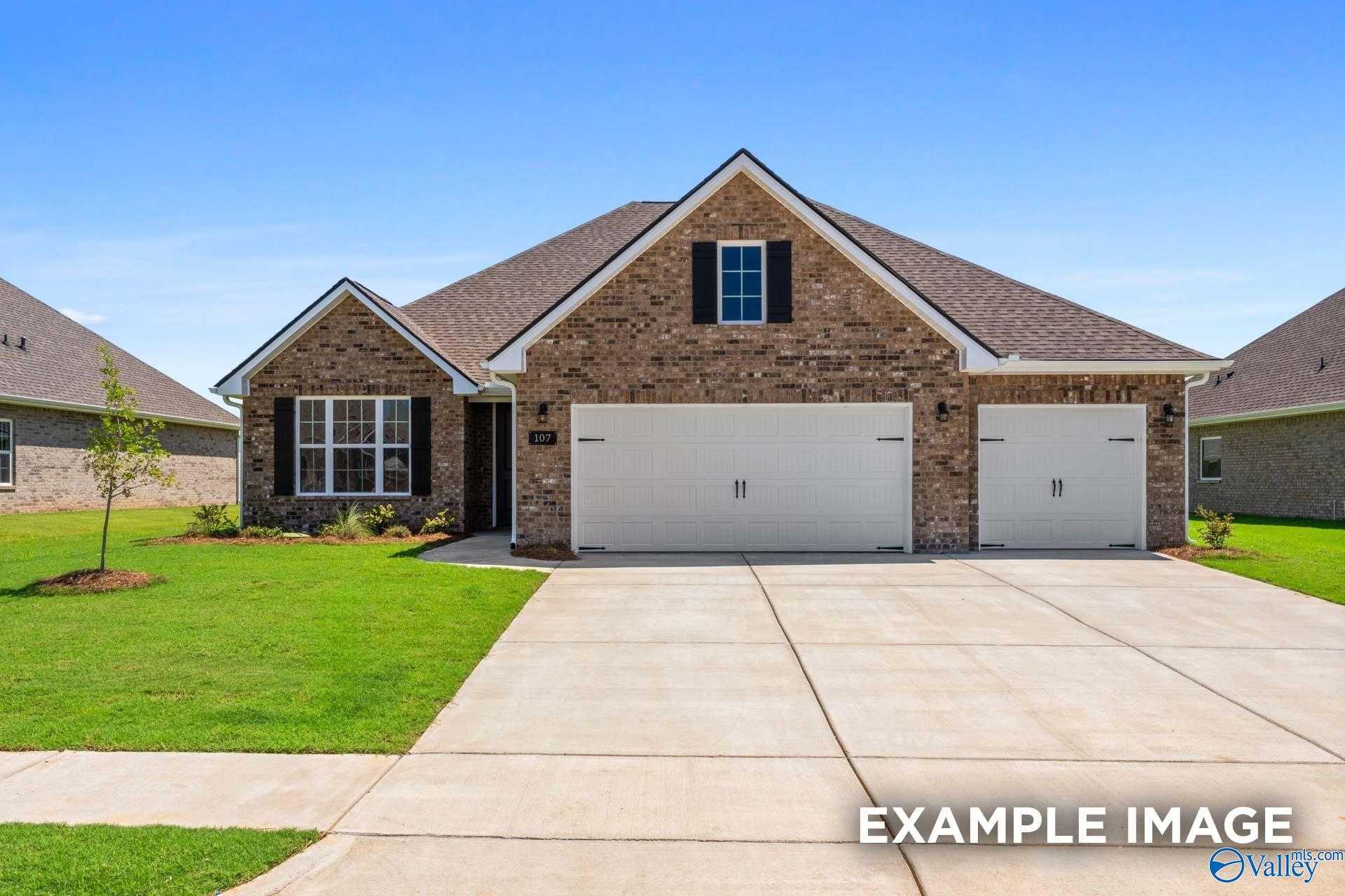 Brick 1-story home with 3-car garage, gabled roof, and landscaped yard in Pikes Ridge, Meridianville, Alabama - Davidson Homes The Lanier