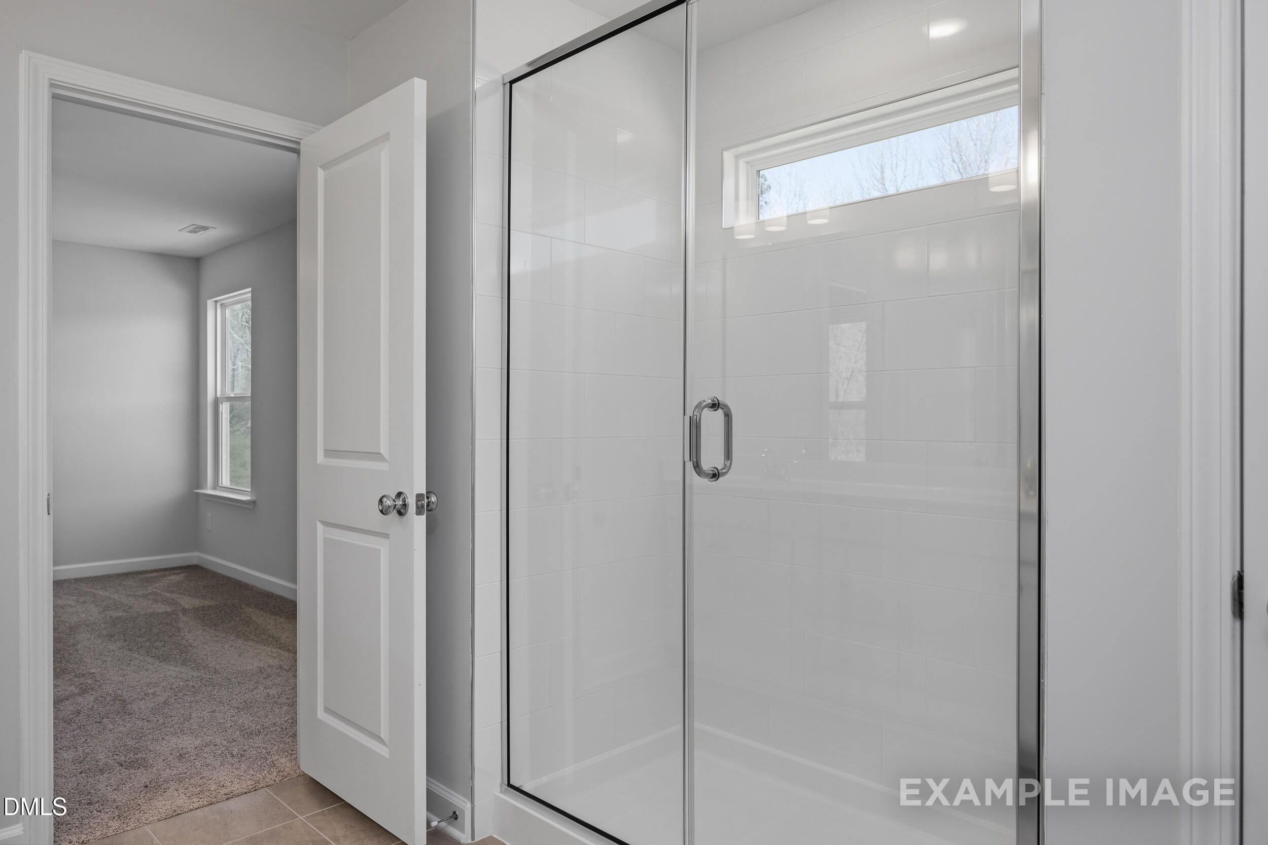 Modern tiled walk-in shower in The Gavin A floor plan by Davidson Homes in Gregory Village, Lillington, North Carolina.