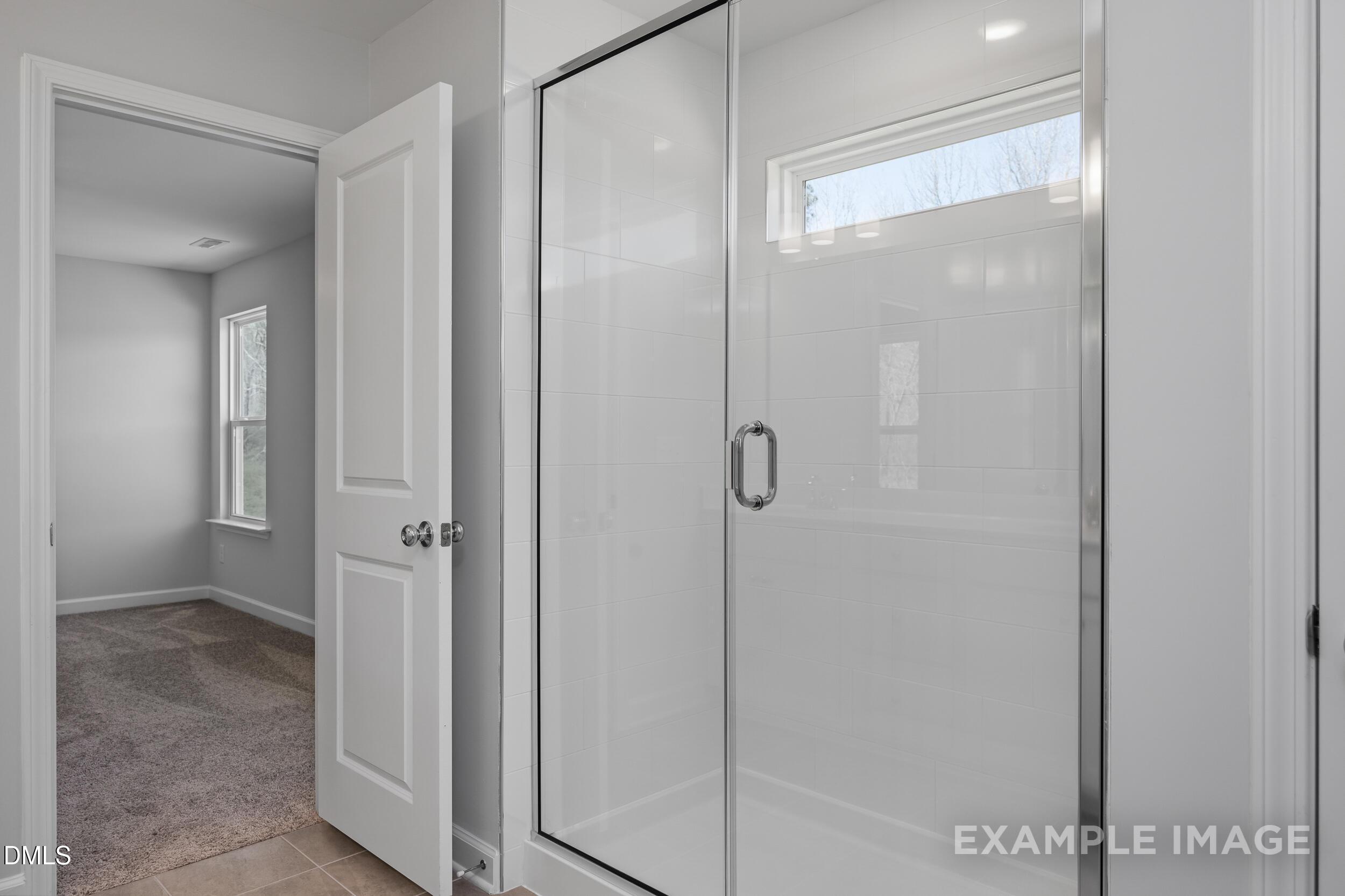 Modern tiled walk-in shower in The Gavin A floor plan by Davidson Homes in Gregory Village, Lillington, North Carolina.