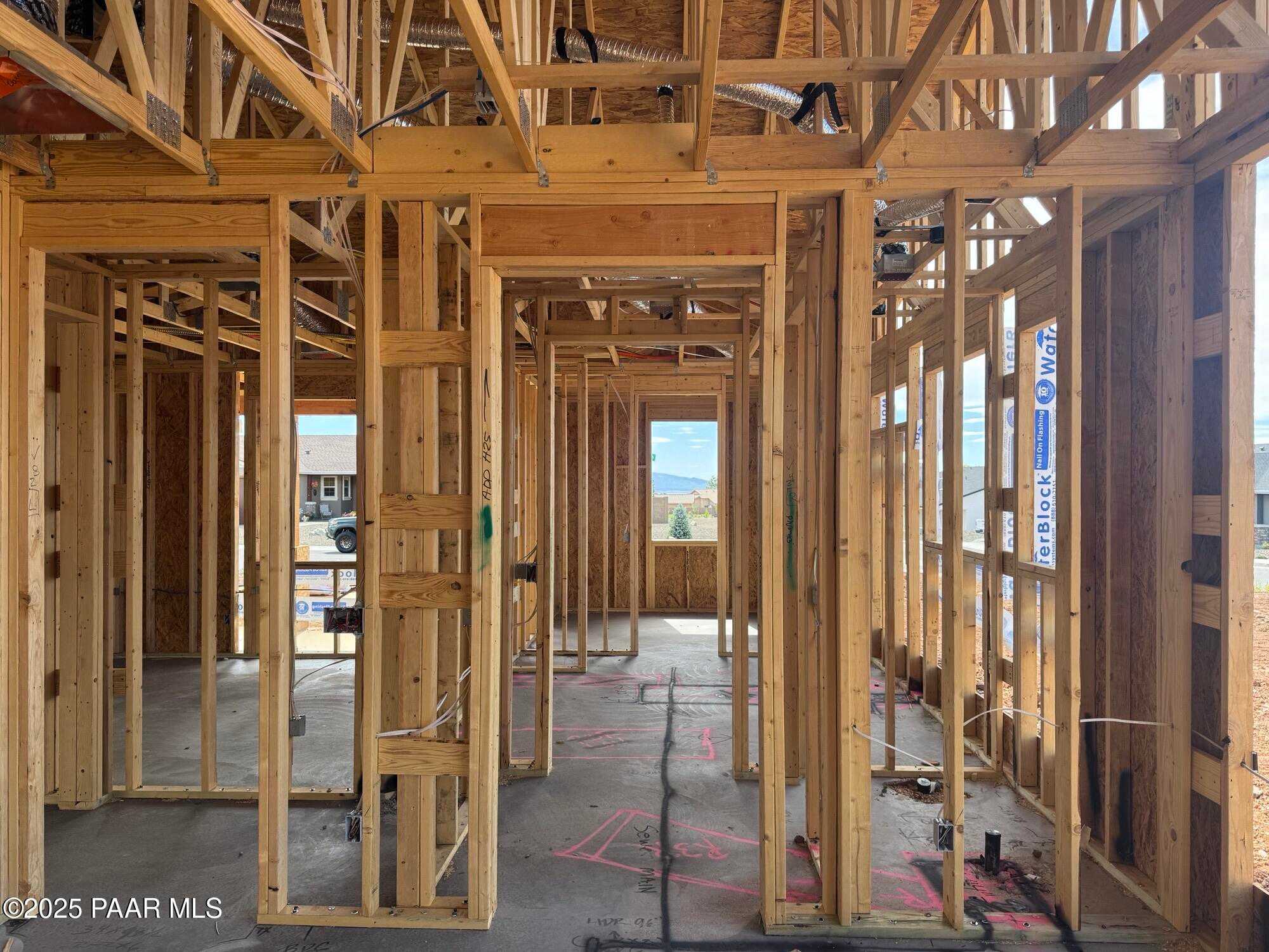 Framed interior of The Monarch B 3-bedroom home under construction with mountain views and open layout in Prescott Valley, Arizona