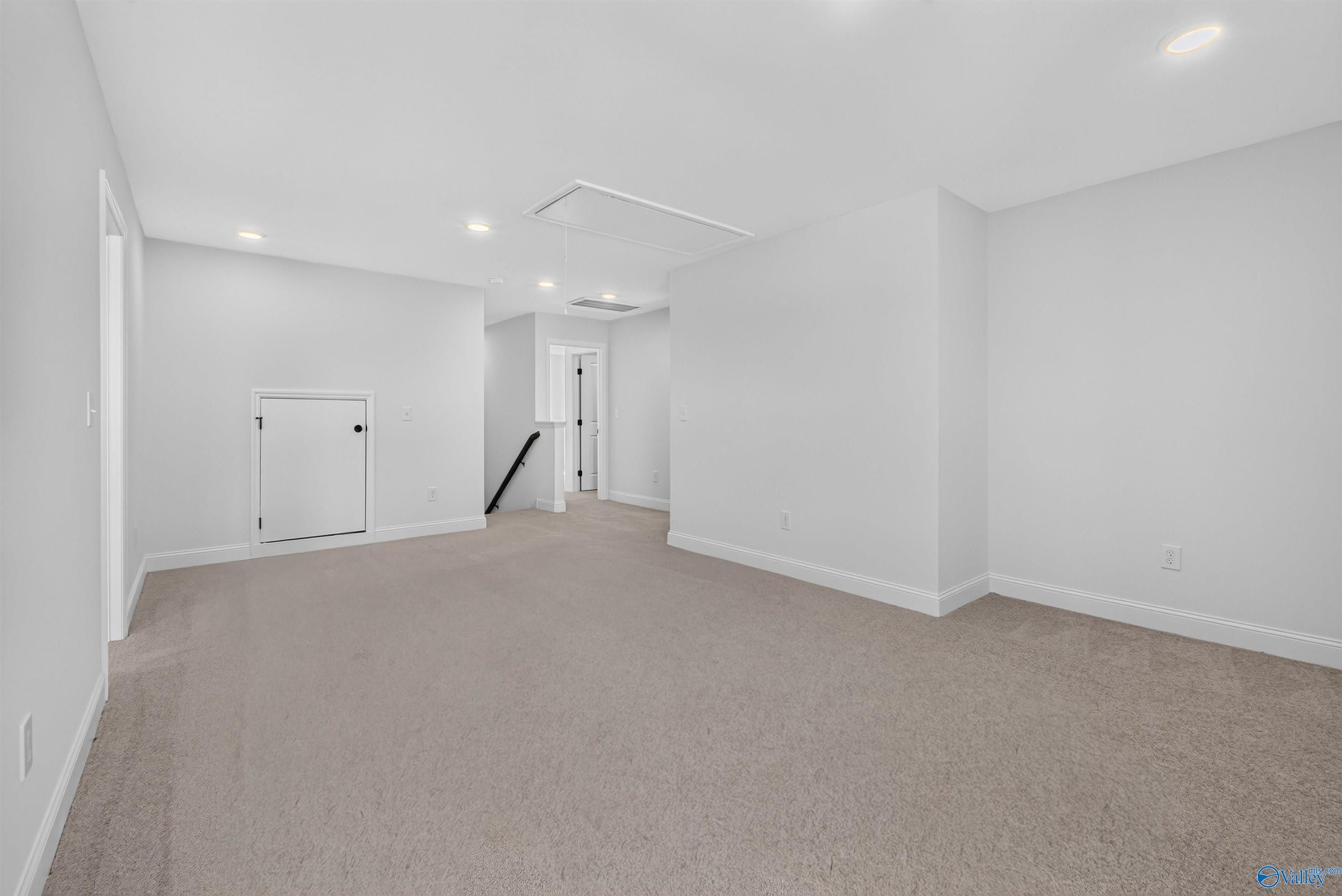 Spacious carpeted bonus room with recessed lighting and attic access in Davidson Homes Ashport L plan, Berry Cove, New Market, AL