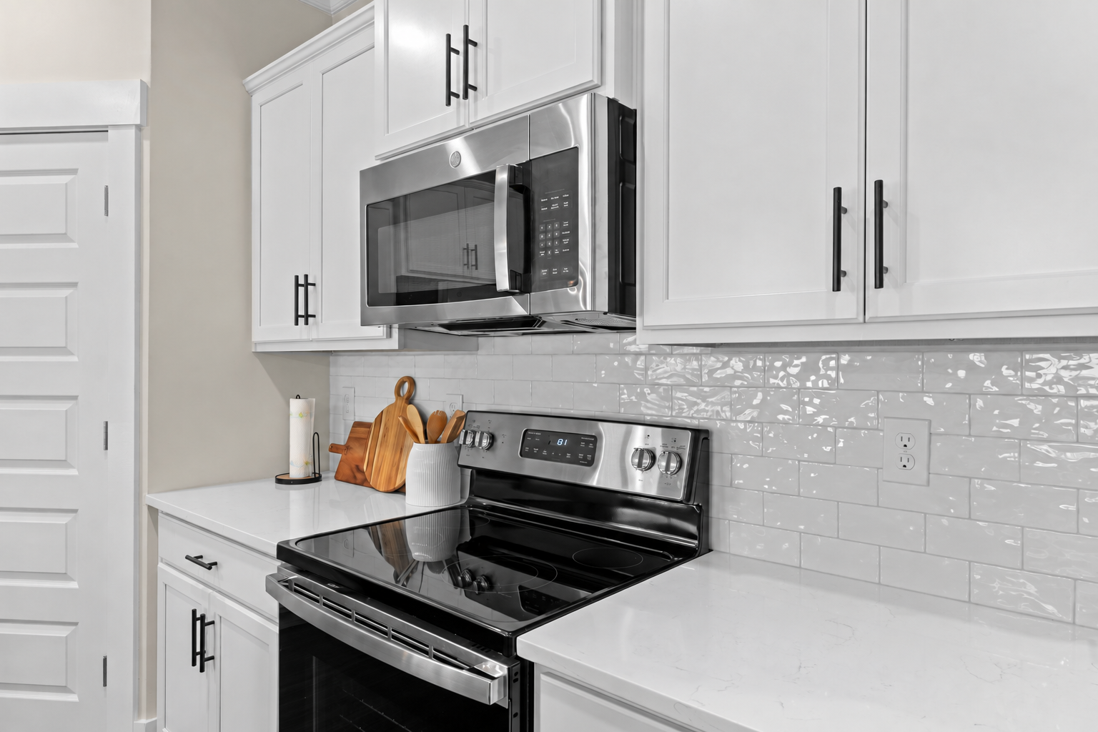 Spacious kitchen in Ivy Hills Toney Alabama with white shaker cabinets, stainless steel appliances, subway tile backsplash
