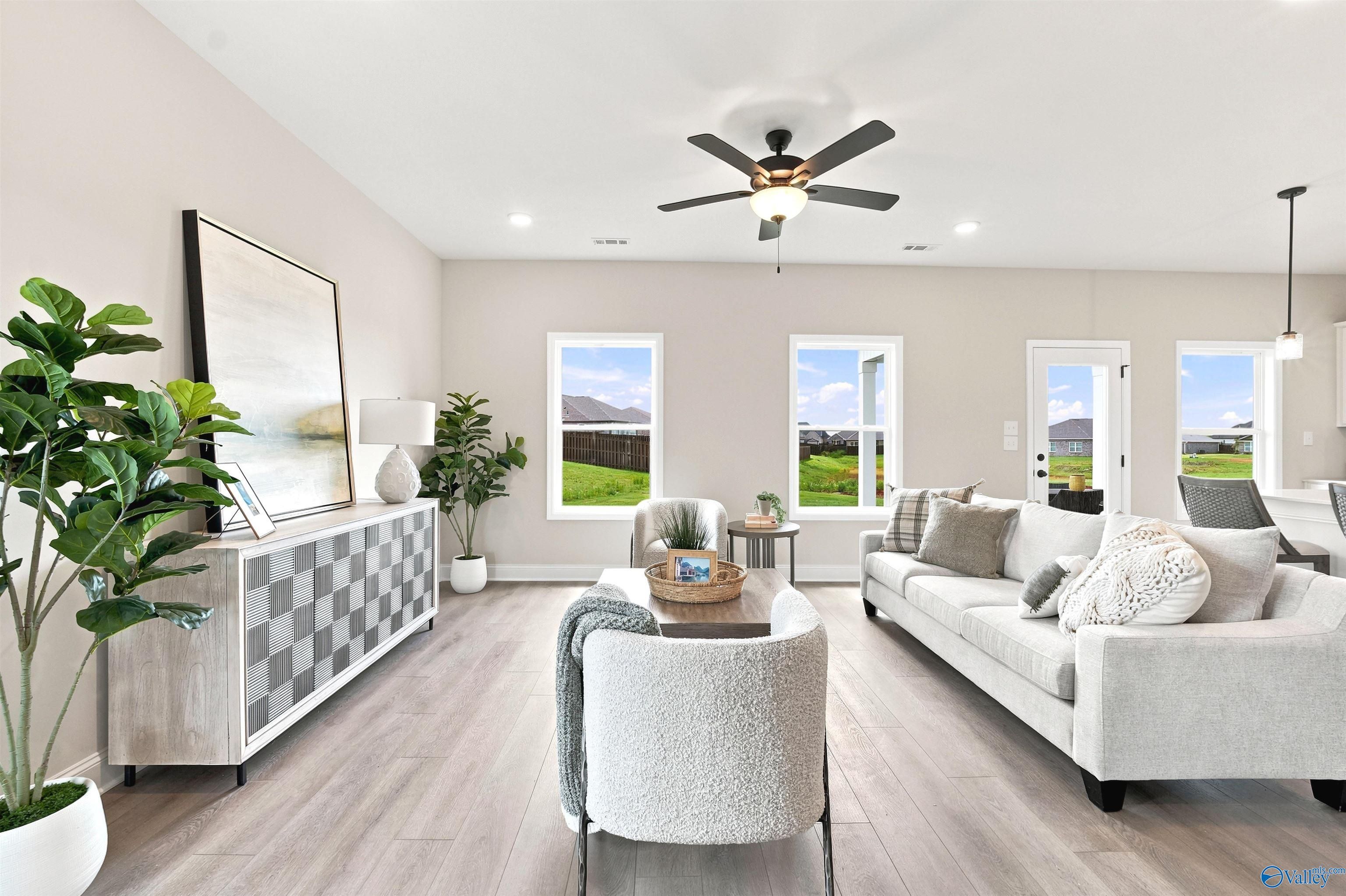 Bright open-concept living room in The Burton B floor plan by Davidson Homes at Heritage Lakes, New Market, Alabama.