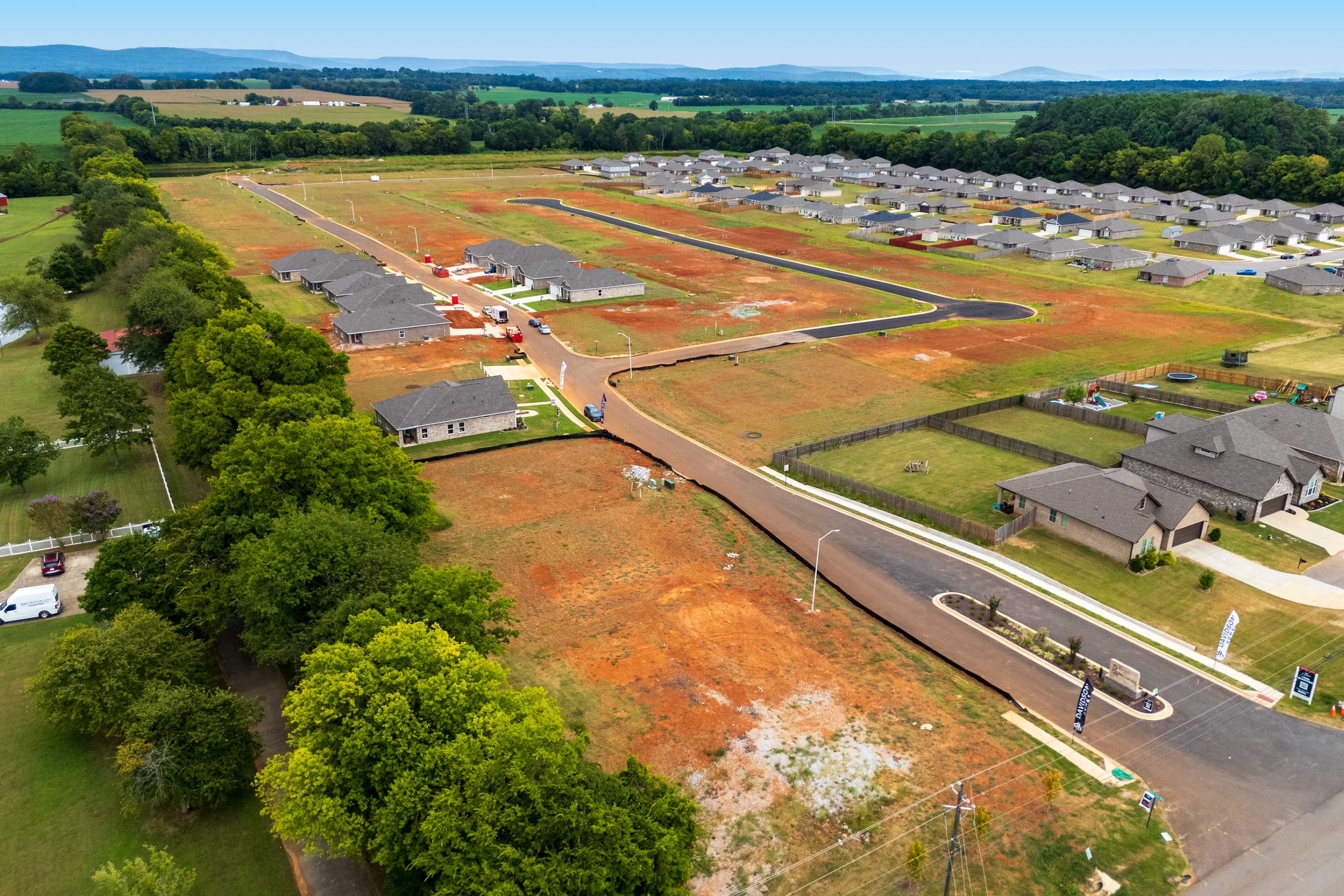 Aerial view of Lynn Meadows neighborhood in Meridianville Alabama with new Davidson Homes, construction sites, and wooded fields