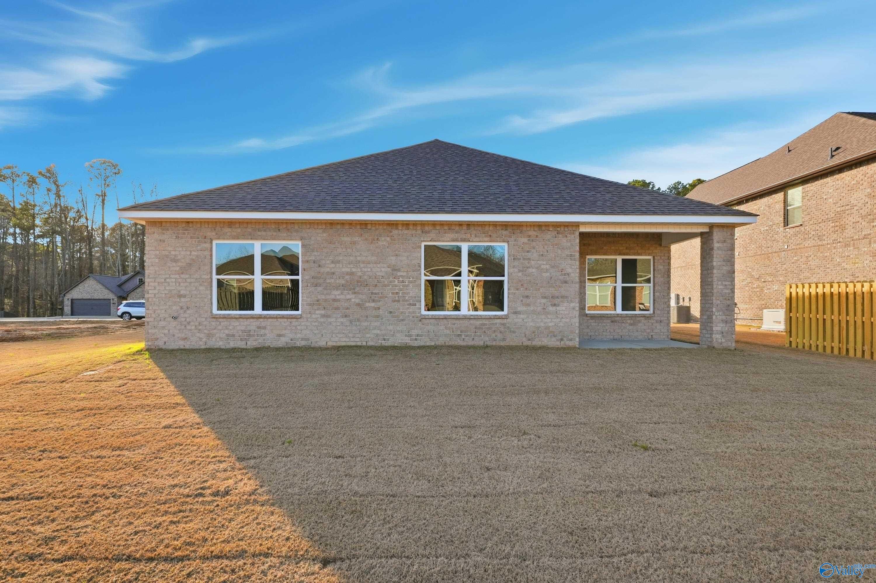Modern single-story brick home with 2-car garage and covered entry, The Daphne D by Davidson Homes in The Highlands, Arab, Alabama