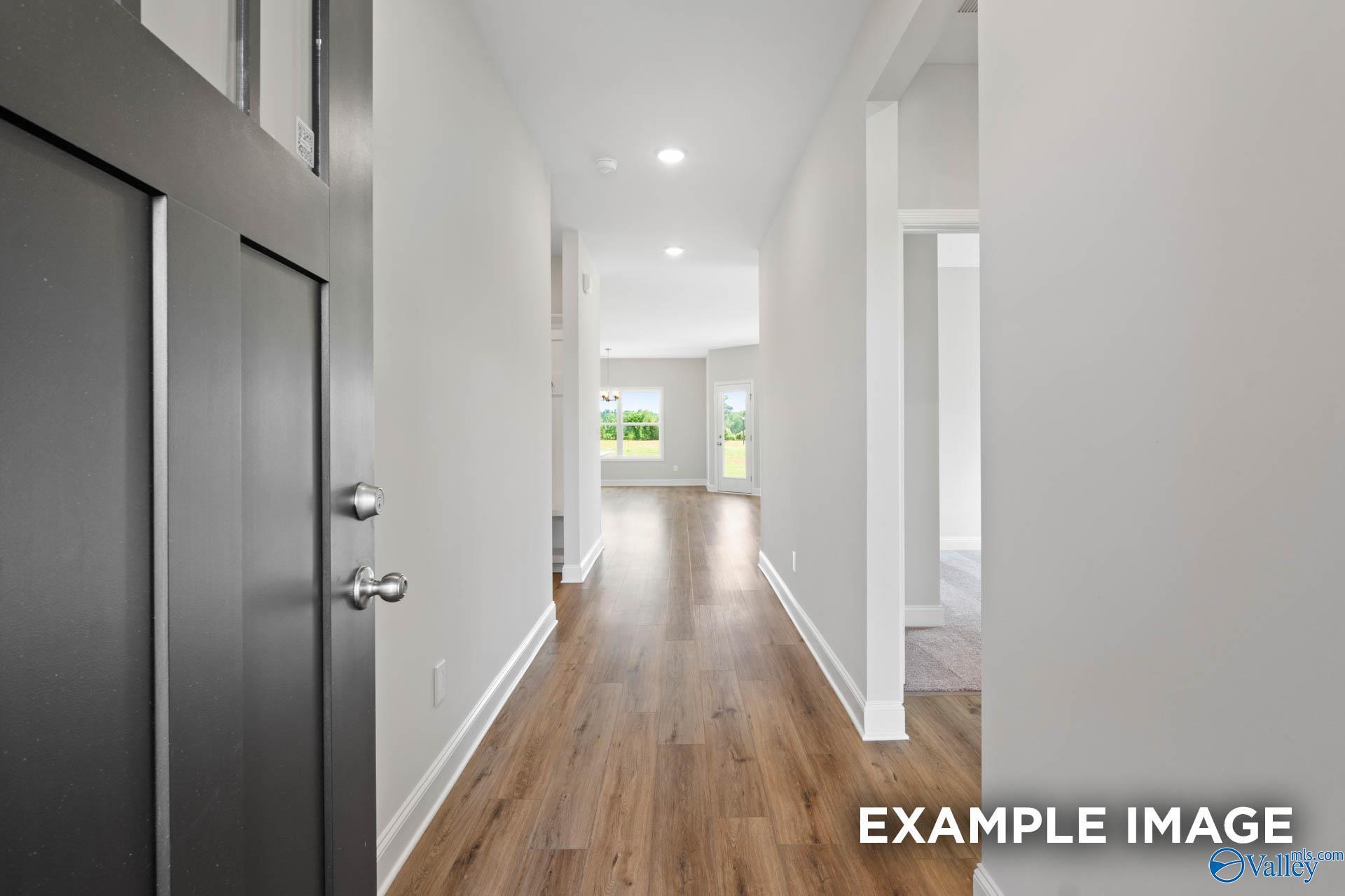 Bright entry hallway with hardwood floors, white walls, and natural light in Davidson Homes The Franklin C, Meridianville, Alabama