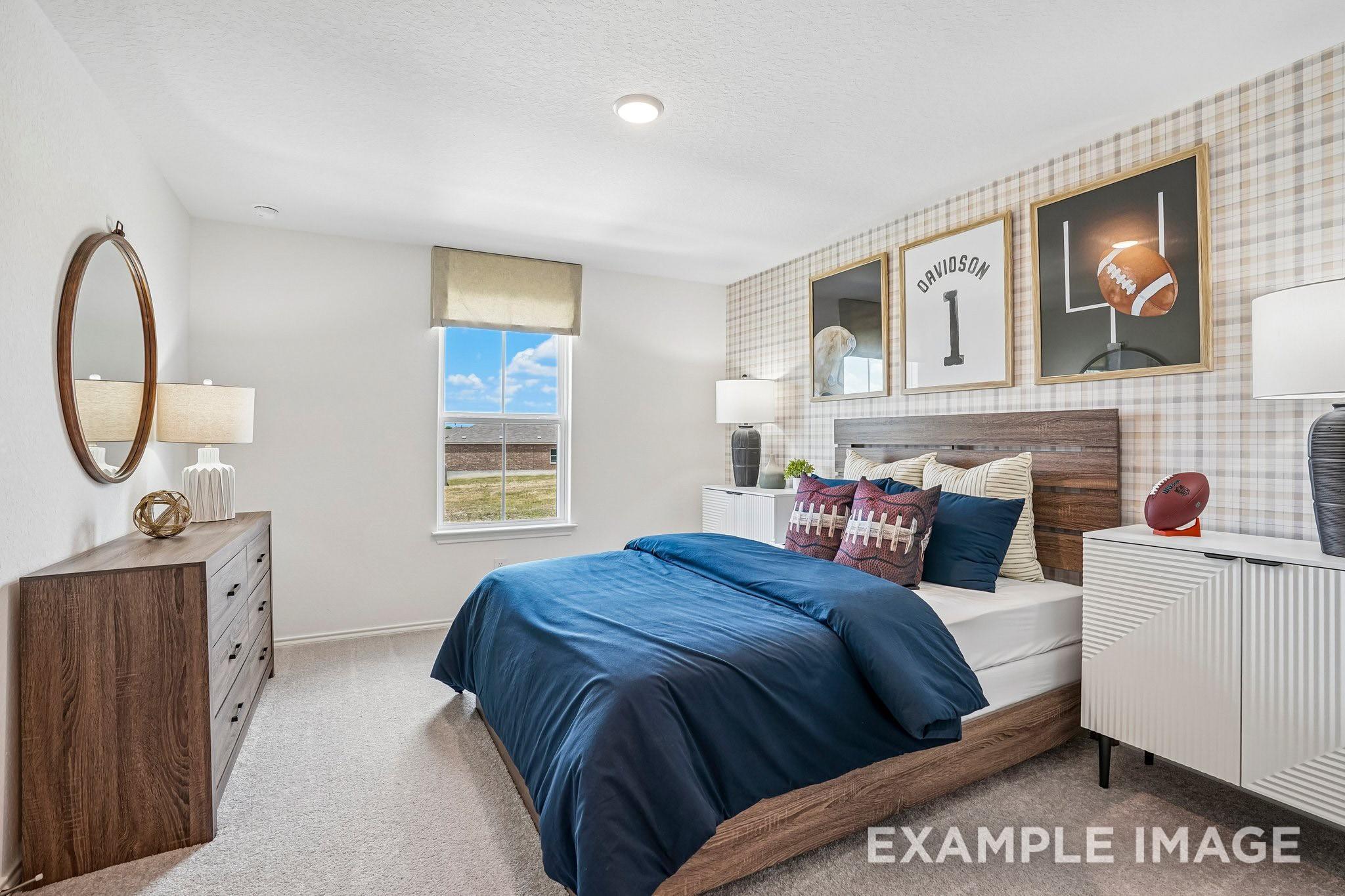 Sports-themed bedroom with navy bedding, wood headboard, and plaid accent wall in Davidson Homes Ashport J, Crosby, Texas