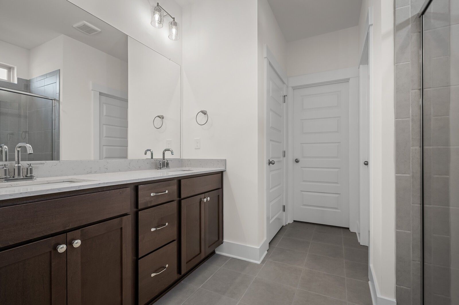 Modern dual-vanity bathroom in The Ash A floor plan by Davidson Homes at Woods Crossing in Gallatin, Tennessee.
