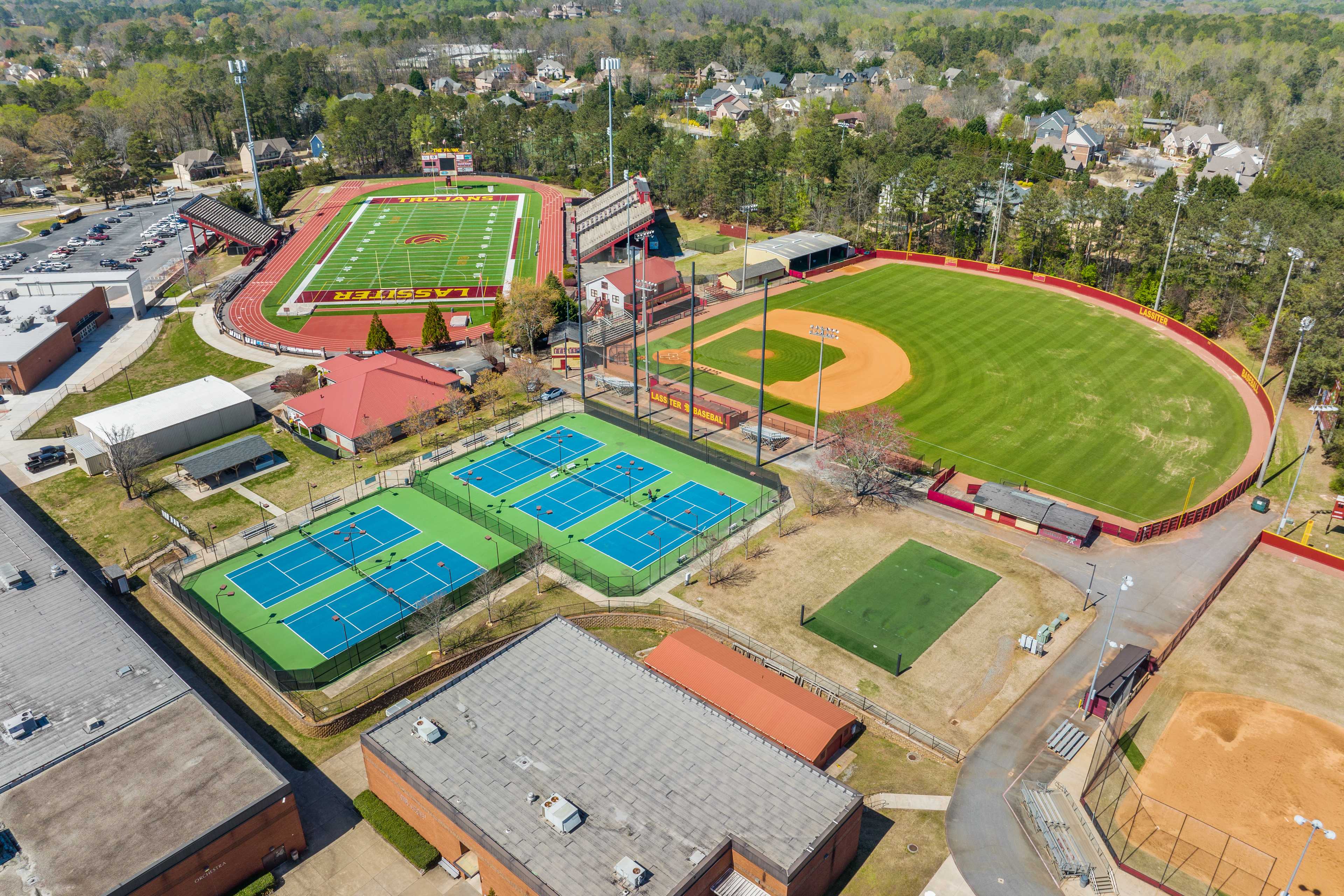 Aerial view of sports facilities at Lassiter Place in East Cobb Georgia featuring football field track baseball diamond and tennis courts