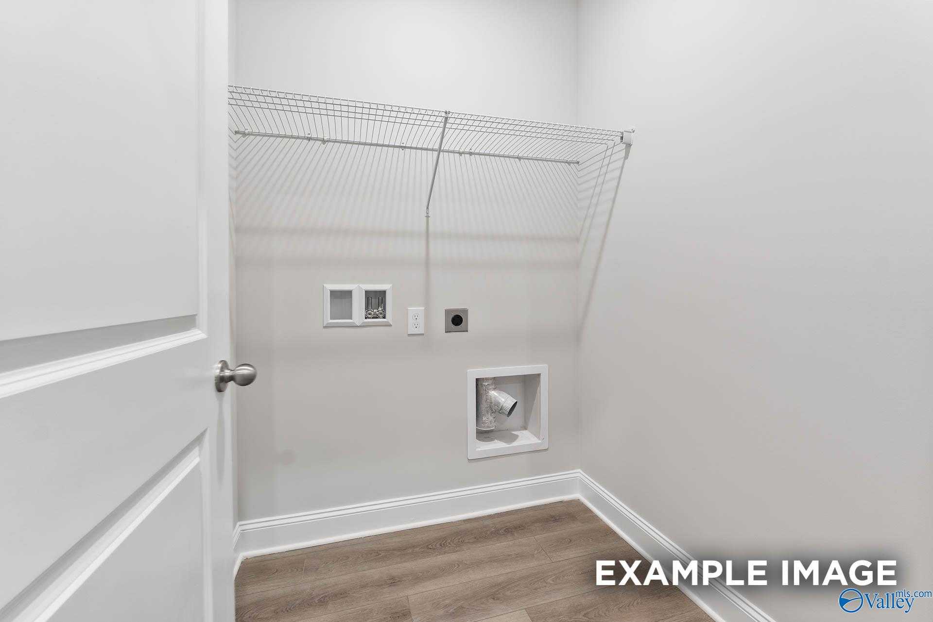 Spacious laundry room with wire shelving and washer/dryer hookups in The Asheville 3-bedroom home, Davidson Homes, Ramsay Cove, Alabama
