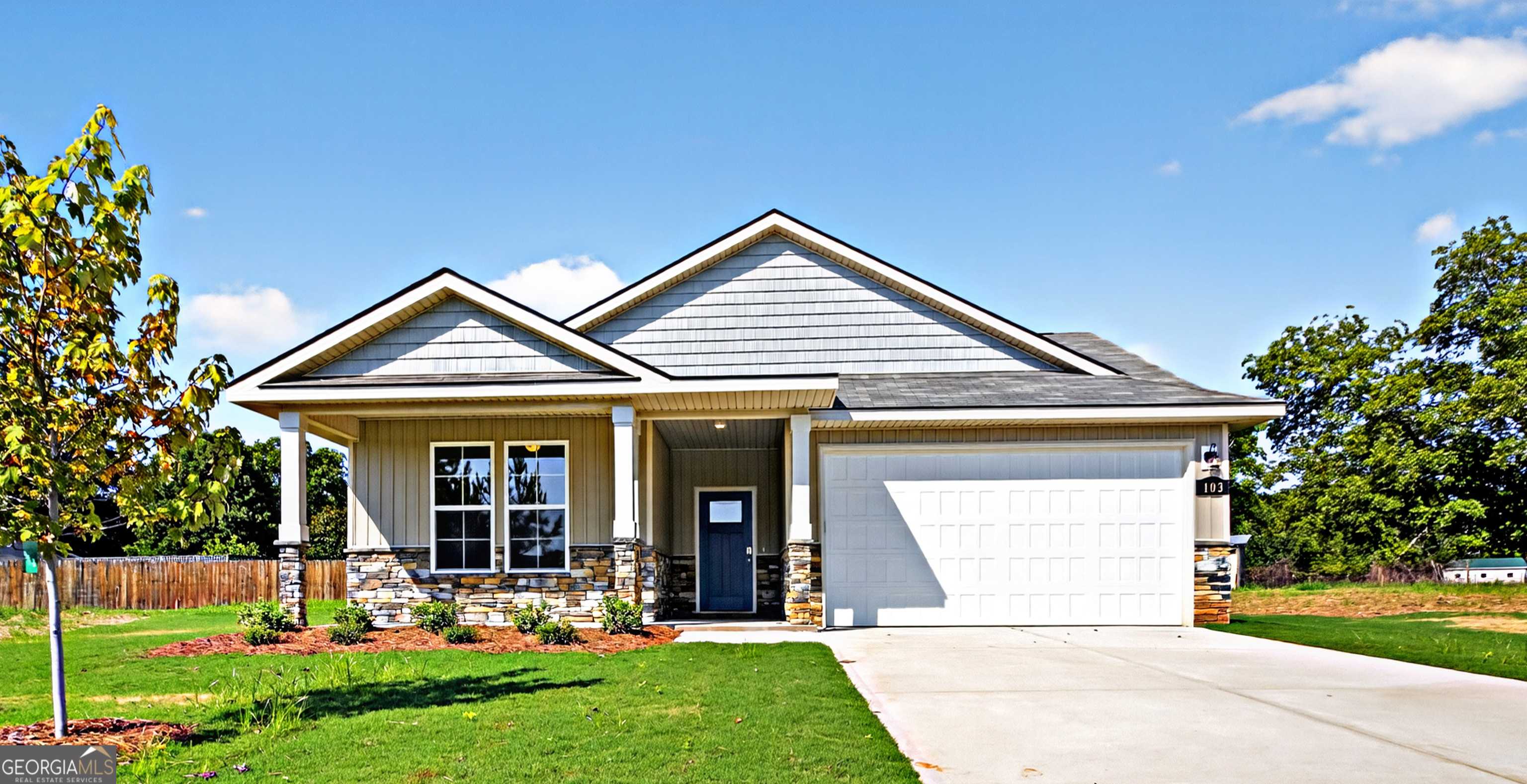 Modern single-story 4-bedroom home with 2-car garage, covered porch, and stone accents in Ivy Glen, Perry, Georgia by Evermore Homes The Luna