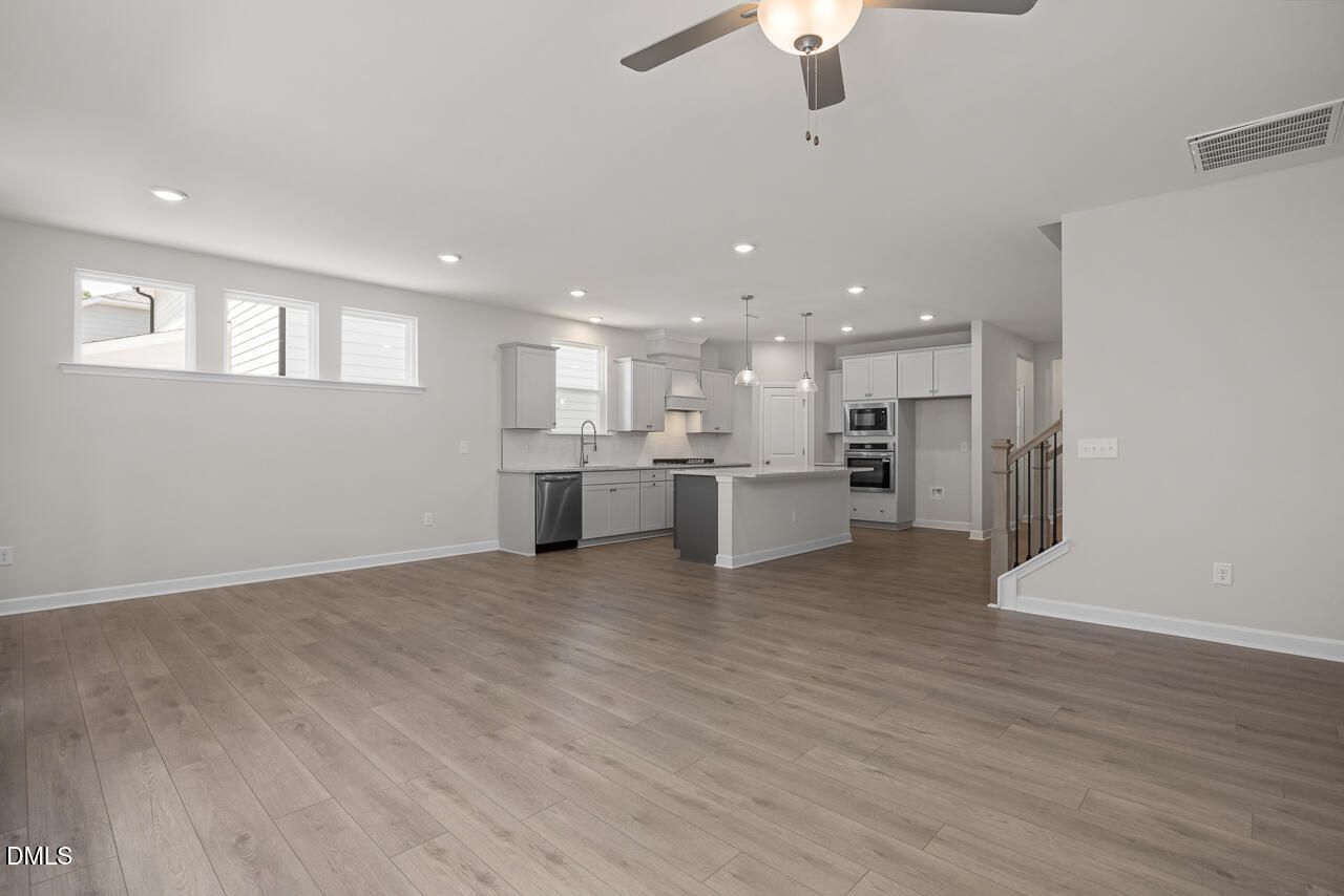 Open-concept kitchen and living area in The Ashport G floor plan at Sage on North Main in Wake Forest, North Carolina.