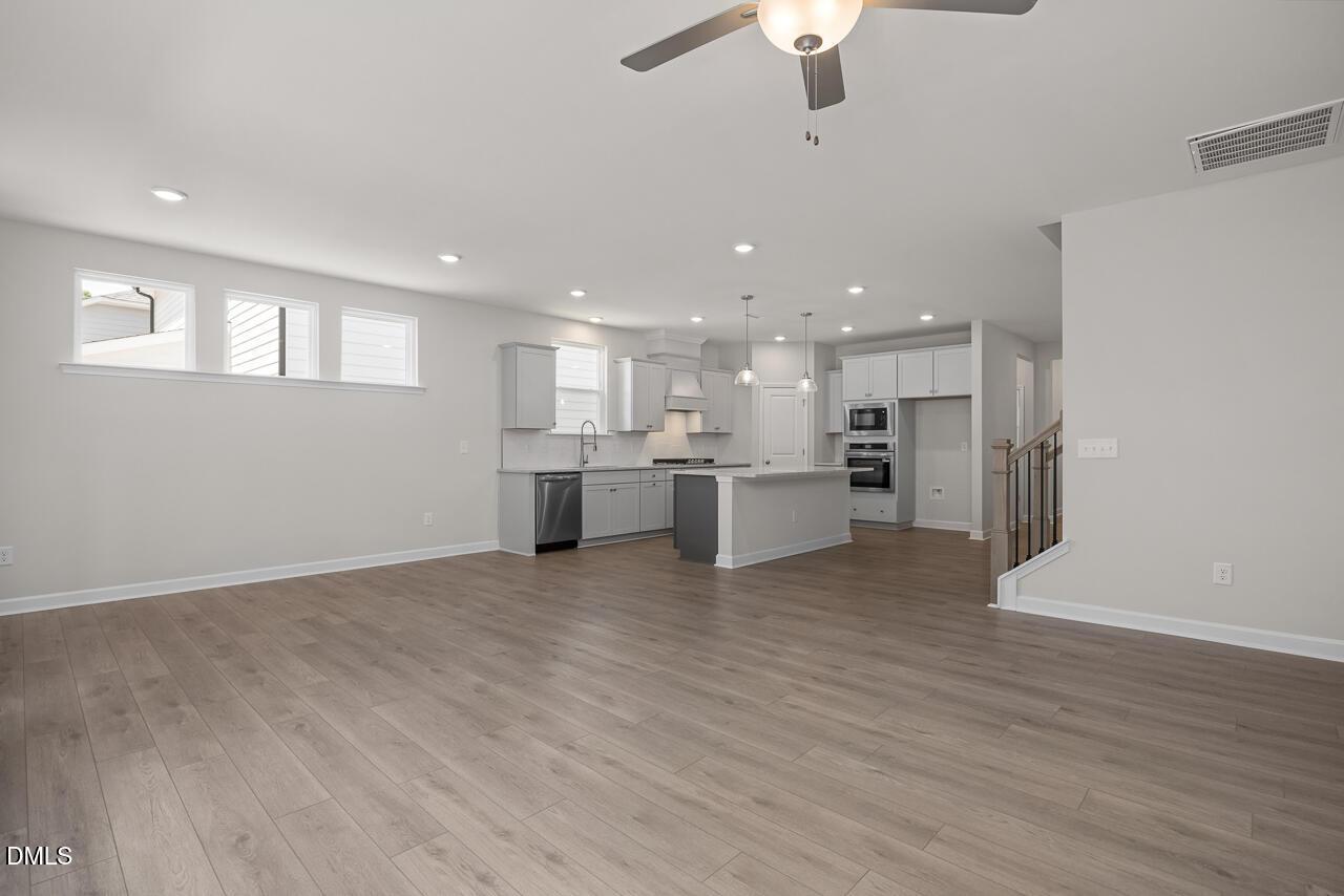 Open-concept kitchen and living area in The Ashport G floor plan at Sage on North Main in Wake Forest, North Carolina.