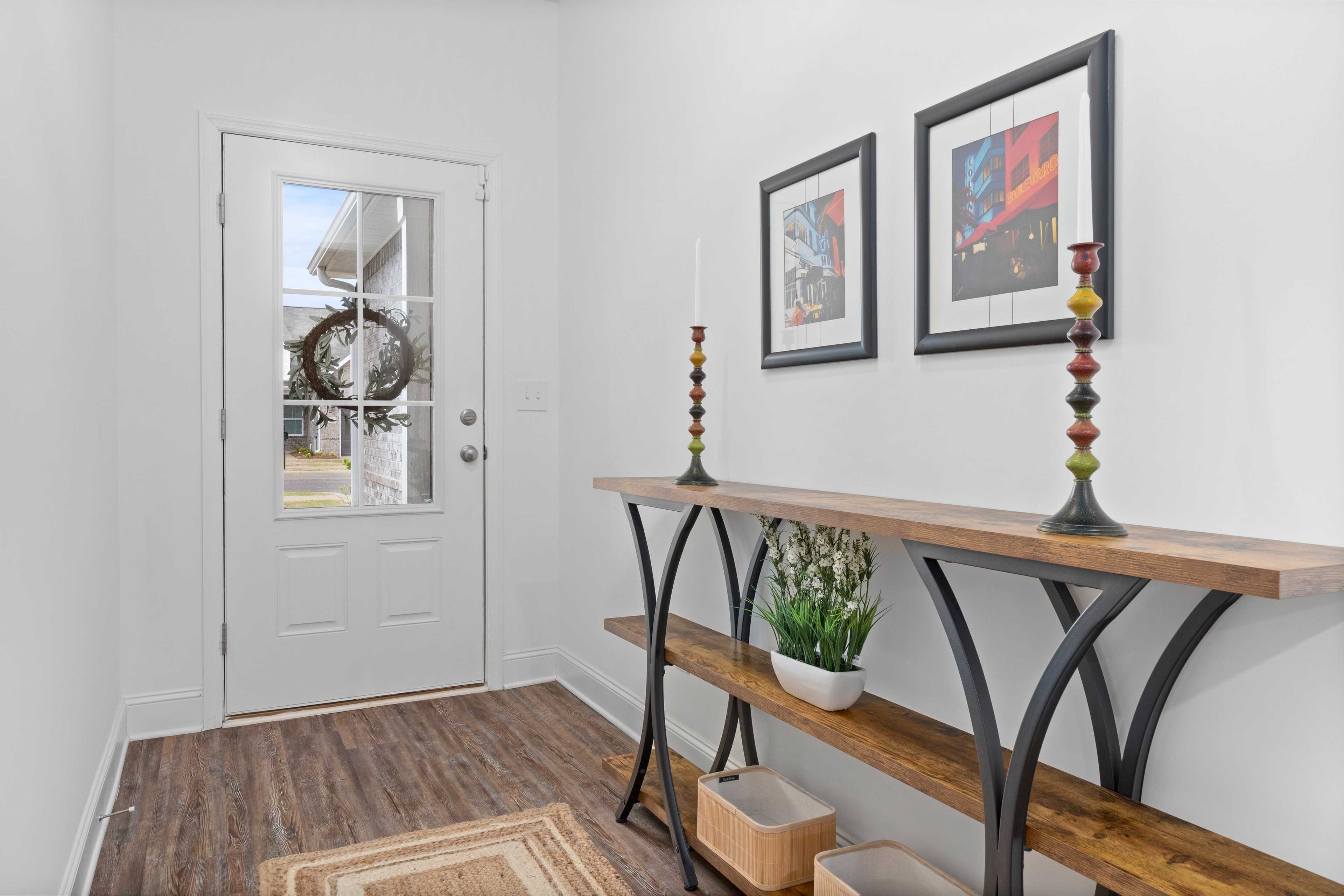 Spacious entryway at The Retreat at Hollon Meadow in Decatur AL with console table, abstract art, and wreath-adorned door