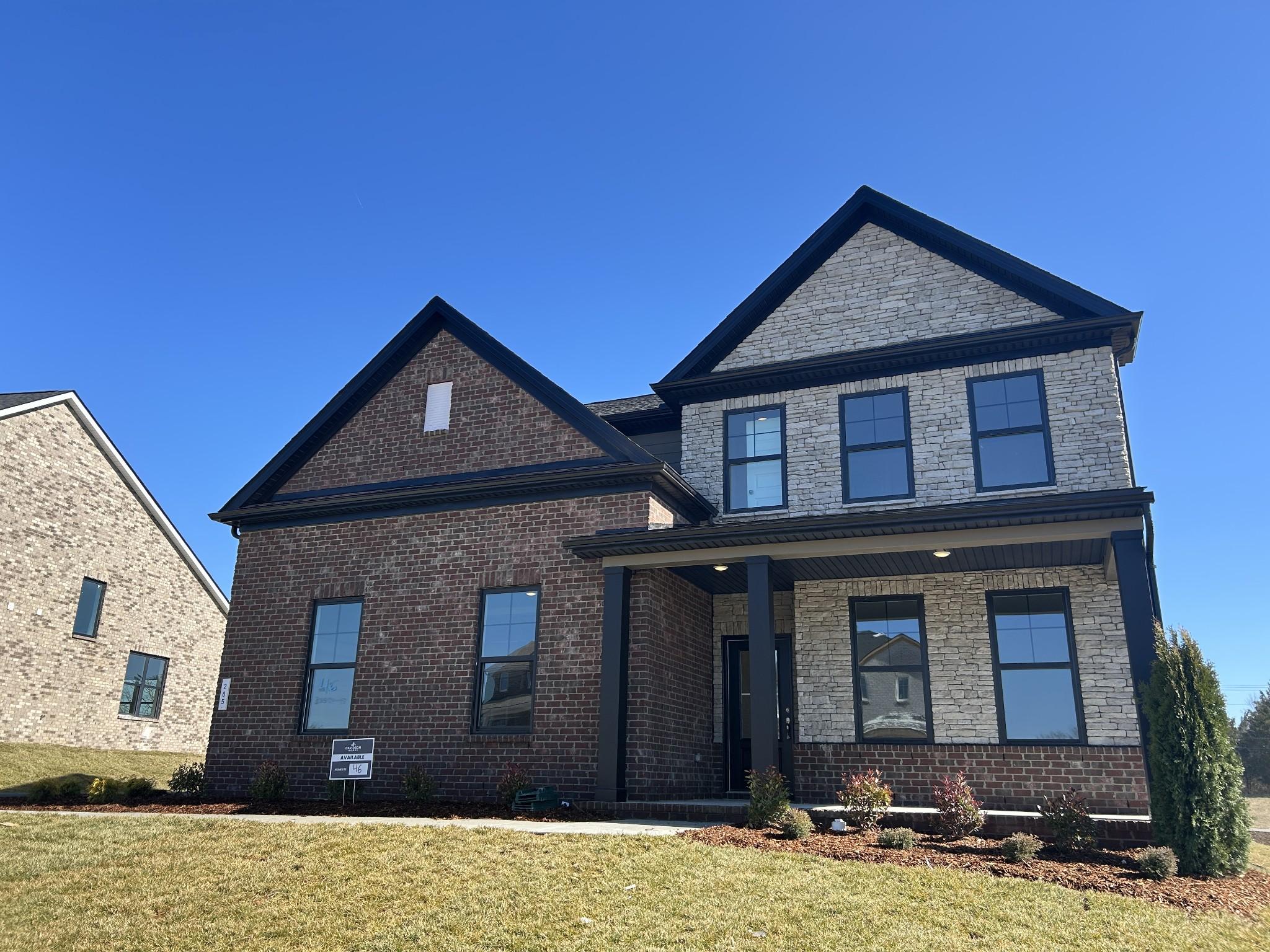 Modern 2-story brick home with black accents, covered front porch, and landscaped yard in Benders Cove, Mt. Juliet, TN