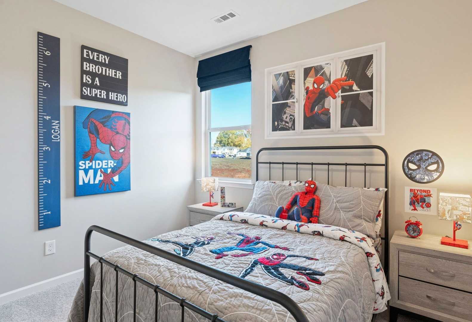Cozy Spider-Man themed boy's bedroom in The Phoenix A with twin bed, growth chart, posters, and nightstand