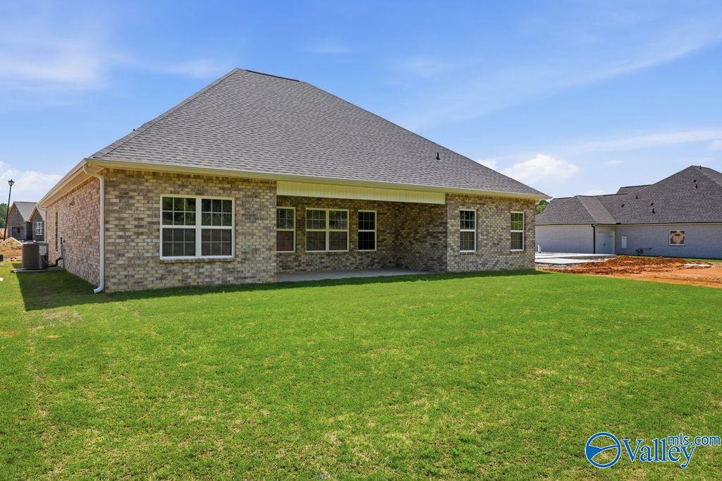Back exterior view of The Rockford floor plan by Davidson Homes featuring a brick facade in Cain Park, Hartselle, Alabama.
