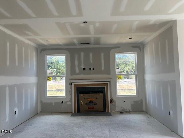 Great room with fireplace and dual windows under construction in Davidson Homes The Ash C plan, Lillington, North Carolina