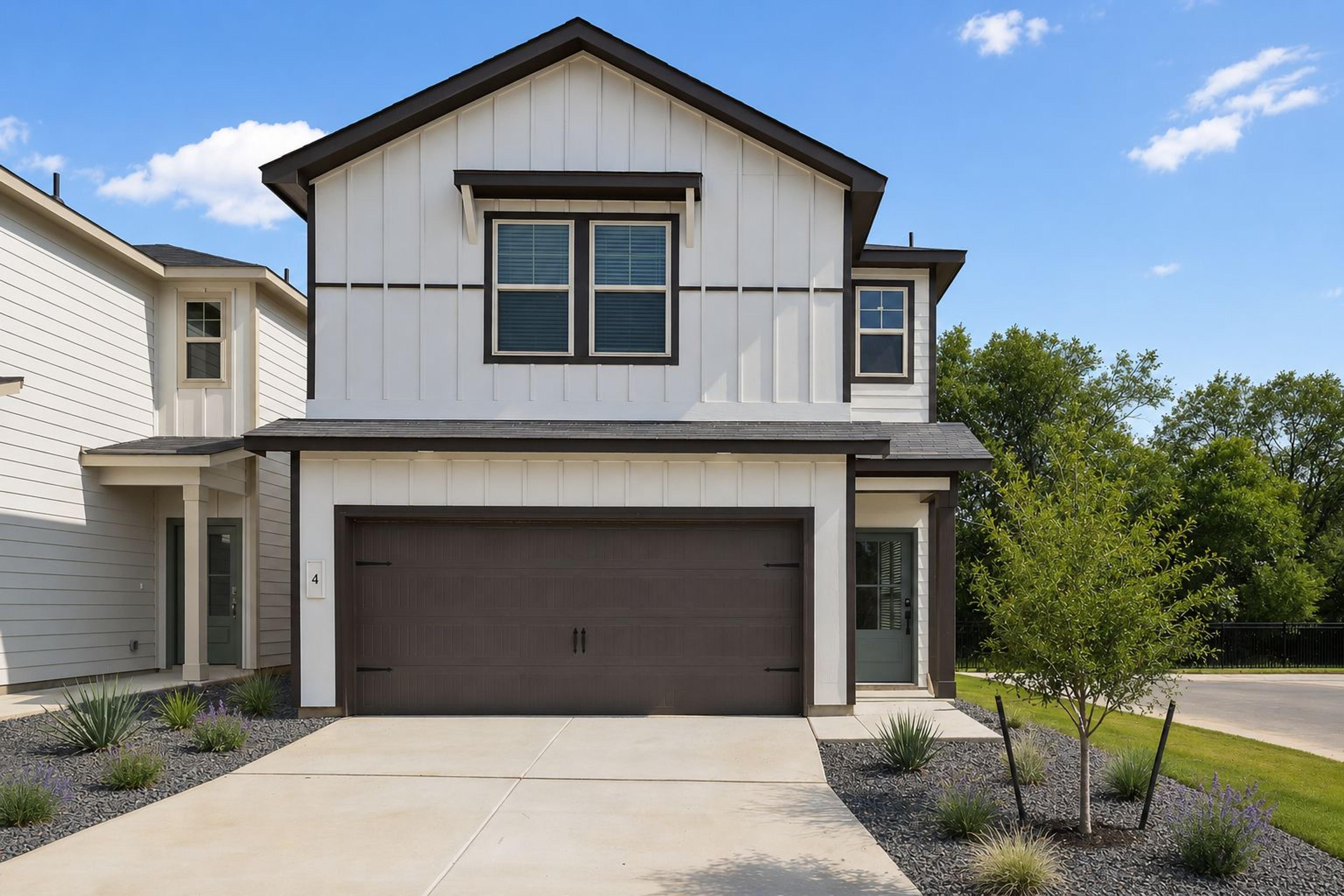 Modern farmhouse exterior by Davidson Homes at Cedar Heights in San Antonio, Texas with a spacious two-car garage.