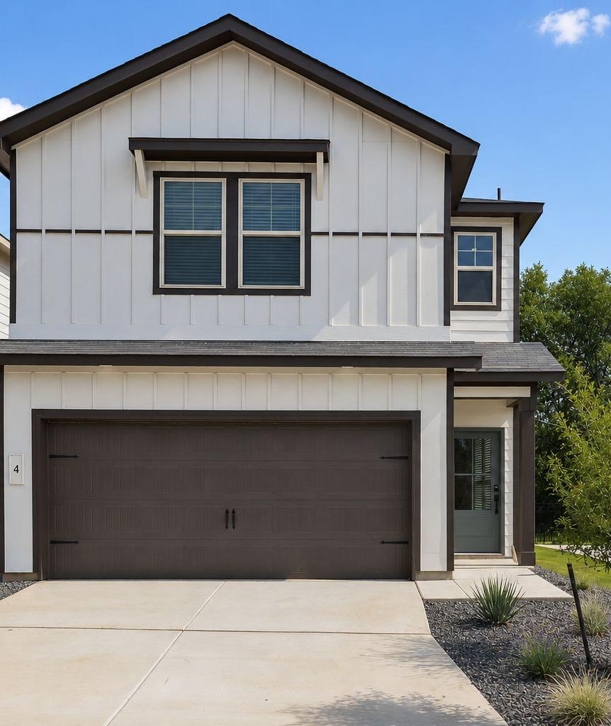 Modern farmhouse exterior by Davidson Homes at Cedar Heights in San Antonio, Texas with a spacious two-car garage.