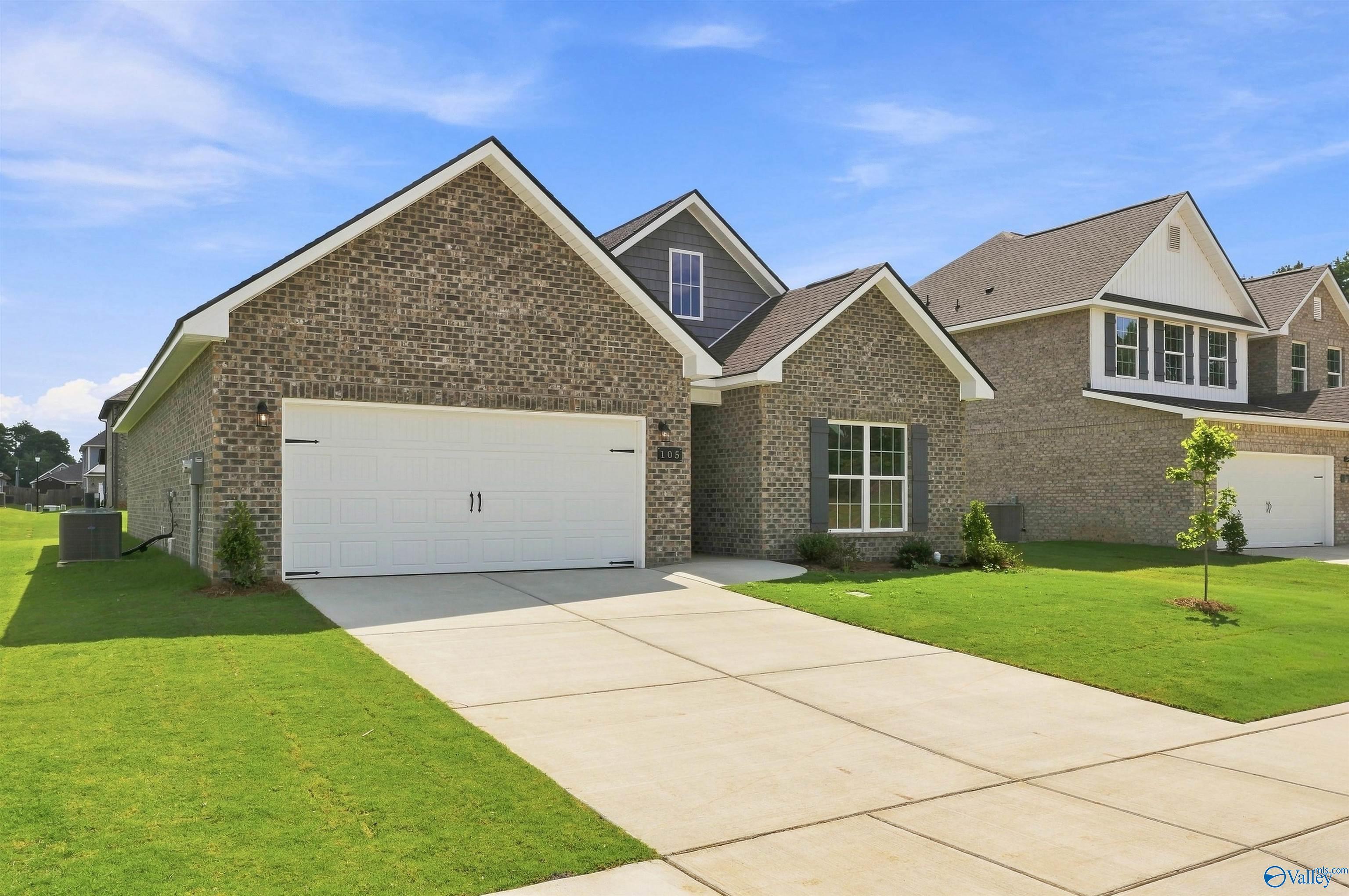 Brick exterior of Davidson Homes The Franklin C with 2-car garage in Wood Trail, Toney, Alabama new construction community