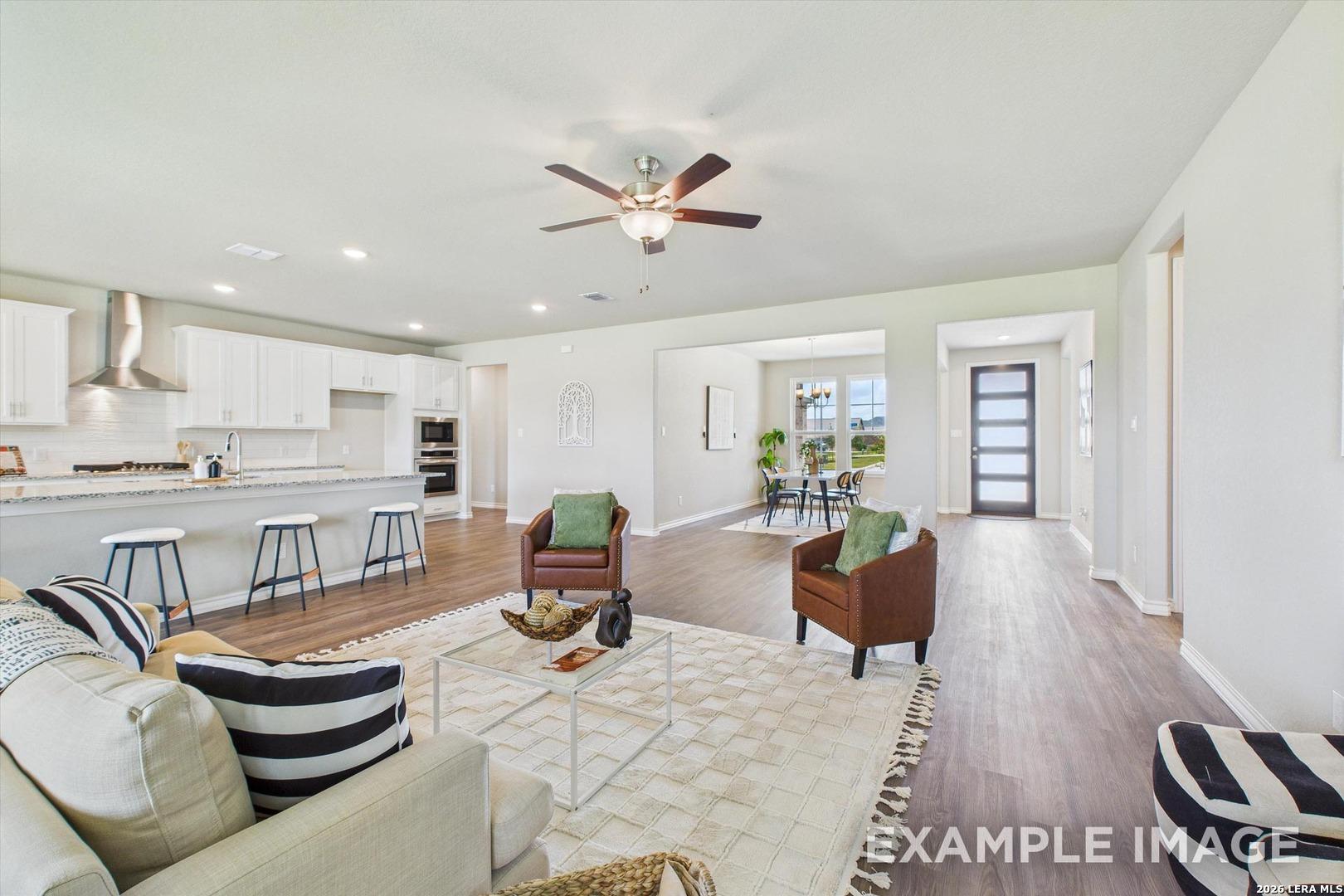 Open-concept living room and kitchen in The Foster F floor plan by Davidson Homes in Potranco Oaks, Castroville, Texas.