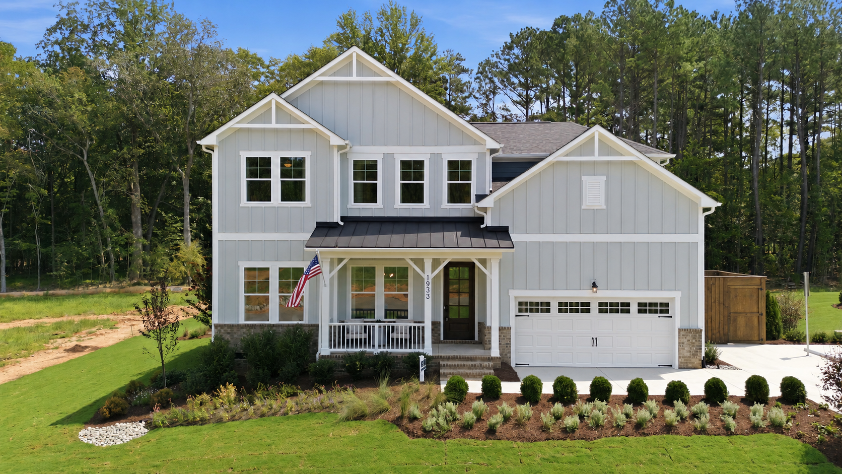 Davidson Homes exterior at Rockport in Wake Forest, NC featuring olive board and batten siding and two-car garage.