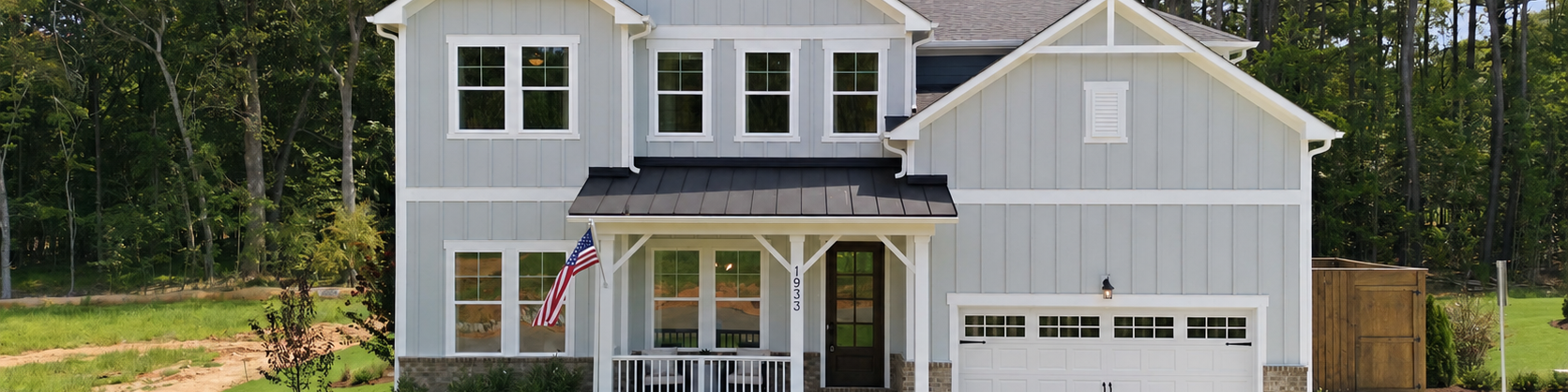 Davidson Homes exterior at Rockport in Wake Forest, NC featuring olive board and batten siding and two-car garage.